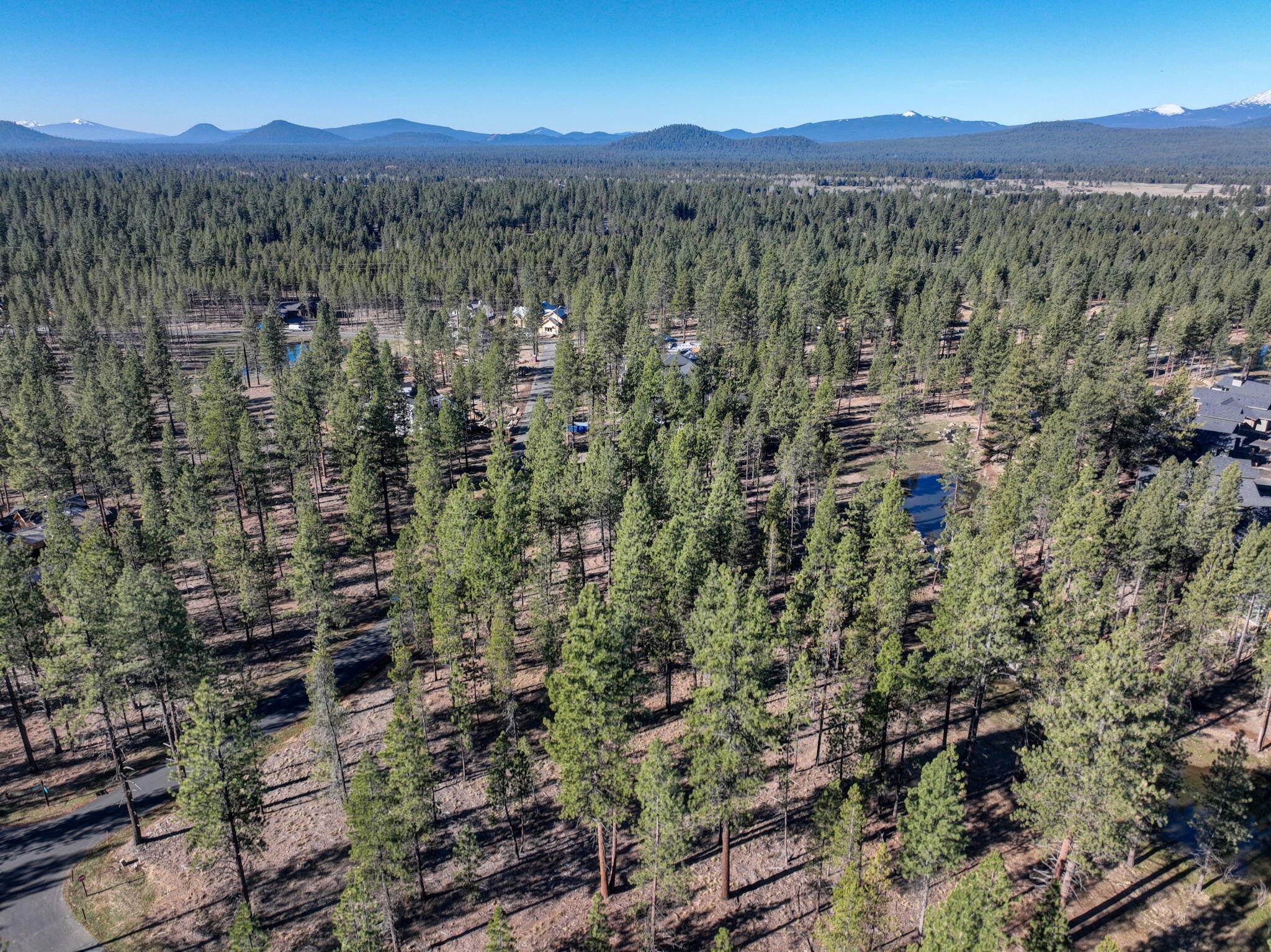 Born from the legacy of Sunriver, Caldera Springs is the Pacific Northwest's premier residential resort community for families seeking a sense of peace, privacy, and four seasons of outdoor adventure. Sited across 1,000+ acres of forests, lakes, streams and trails, each home and homesite has access to an array of exclusive amenities creating a one-of-a-kind wilderness getaway and just 15 miles from Bend. Homesite 327 offers a gradual slope downward toward the north with possible views of Mirror Rock Lake  and stream with a sunny western exposure. This larger coveted 25,700 sq ft lot size may allow a 6 bedroom home to be built. Buyer to review the attached ARC Guidelines.  Short term rentals are allowed in the community, no permit required. Call today for the plat map and begin designing your vacation, or second,  home getaway.
