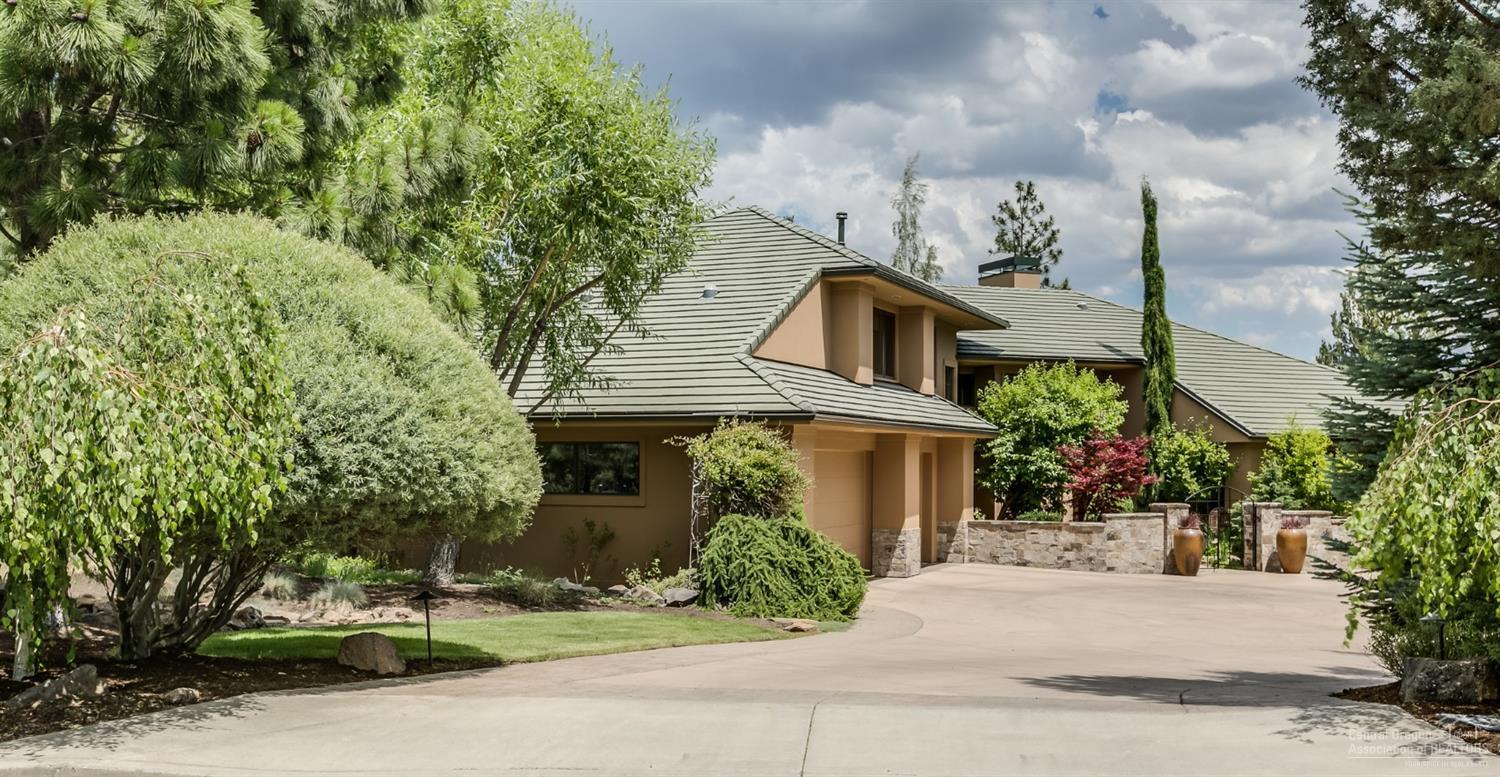 Elegant Awbrey Butte residence, light & bright with expansive NE Mountain & City Views. A large flat driveway off a quiet cul-de-sac & tile roof are stand out features for the Awbrey Butte neighborhood. Expansive Northerly, Cascade Mountain, Smith Rock and twinkling lights City views. Impressive Chef's kitchen with new Thermador SS Appliances, gas fired bread/pizza oven, double islands, tons of custom cabinetry, storage & a restaurant style pantry. With the Main level master suite & private office, this home lives like a one level with no stairs at the entry or from the garage. Upstairs are 2 bedrooms, full bath and a library loft. Downstairs is the Guest bedroom, a true theater room & the temperature controlled 3800+ bottle wine cellar. South facing indoor garden brings light & nature inside year round. Extensive outdoor living spaces with multiple stone patios & water features, beautifully landscaped & lighted- especially usable in the summer months with relief from the Western sun.