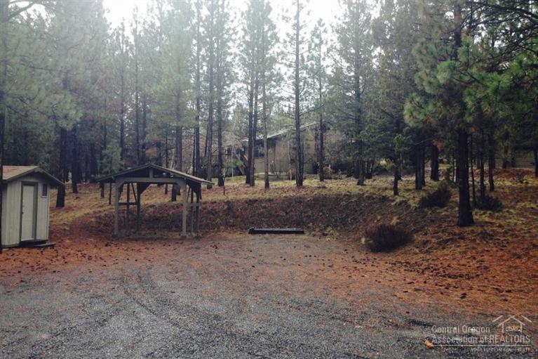 Located on the west side of Bend, this is a rare find with 5 acres, single level home and shop set in the pine trees. Home includes 2 bedrooms, 2 baths, plus den and office that could easily convert to bedrooms. Master has vaulted ceiling, dual sinks, 3 closets and access to backyard area. Utility room includes a sink and built-in cabinets. Large fenced dog run, detached 24x36 shop with built-in cabinets, garden shed, backup generator and decks for entertaining. Beautiful, private setting in the woods!