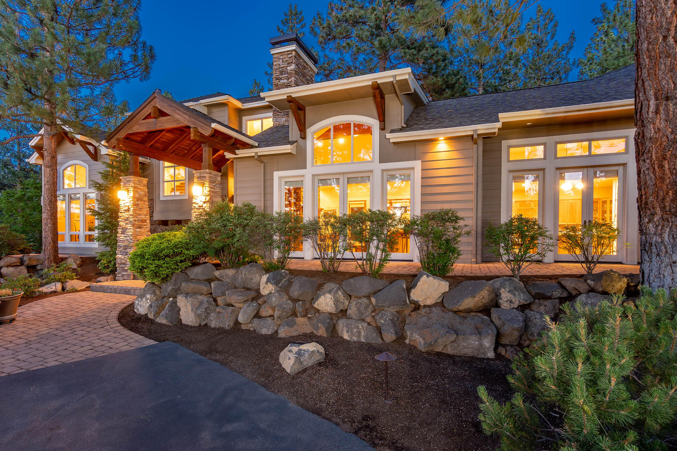 Privacy abounds in this 2002, custom-built, Dave York Home Builder magazine stunner. Featuring a primary level living design with an open layout, this home's vaulted ceilings, hand carved wood doors, trim, and custom built-ins set it apart. Enjoy a chef's kitchen with a six-burner stove, high-end appliances, a built-in security system, and surround sound capability. An entertainer's dream with expansive outdoor space and beautiful gardens, including private patios and hot tub access from the owner's suite. Peekaboo mountain views greet you upon arrival. The gardens feature french drains, blooming perennials and mature trees. Don't miss the large garage, with a shop area built into the third bay - a woodworker's dream, complete with shop vac. Two bedrooms and a shared ensuite await upstairs, with loft space for work or play. Ample storage, dual zone cooling and water heaters add to the move-in ready appeal. Around the corner from the park and playground!