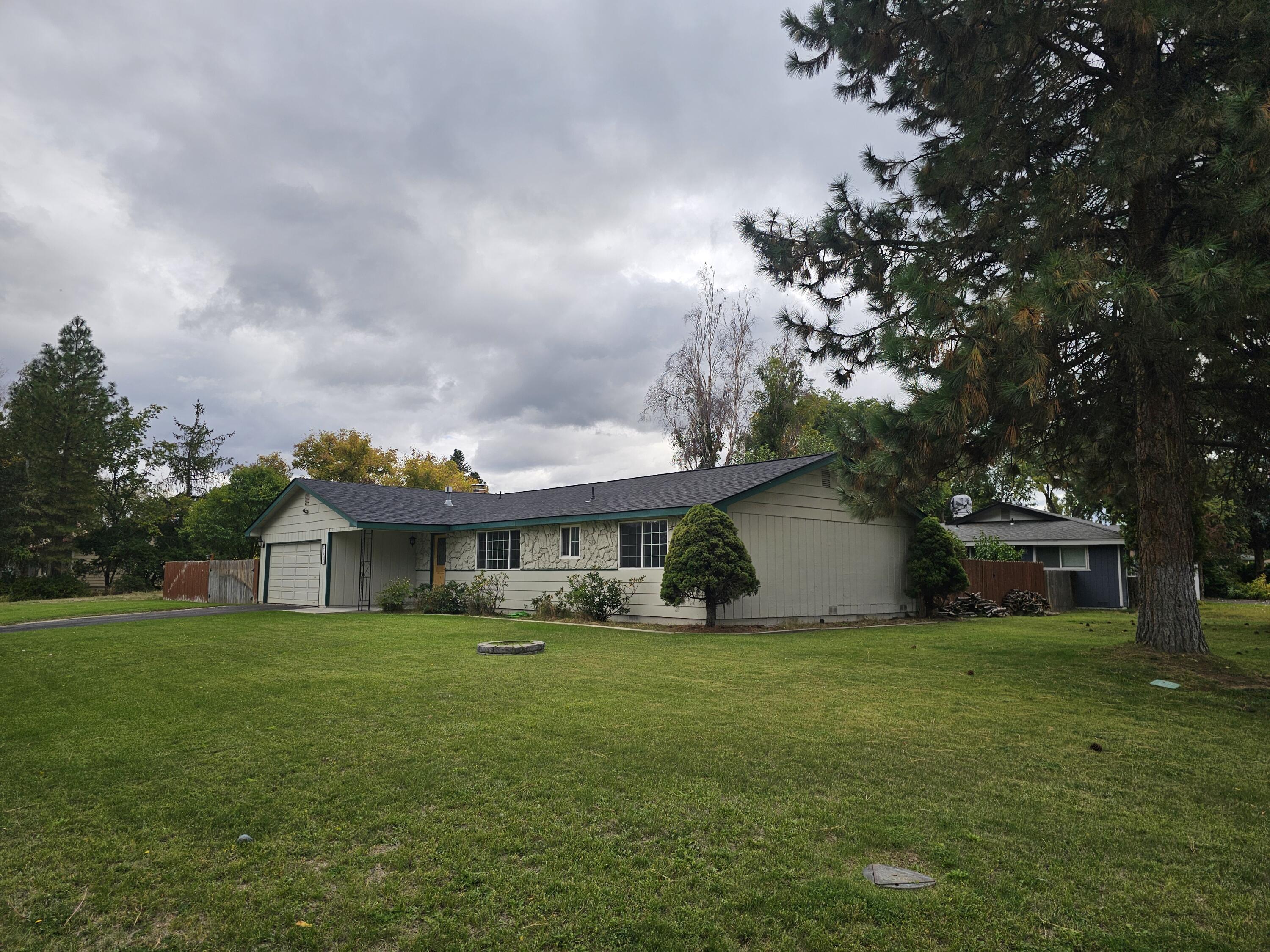 This is an amazing 3 bedroom 2 bath home on a large corner lot! All fresh paint inside and out with a new roof. Updated vanities in the bathrooms, heated floors in the primary bathroom, ALL brand-new floors throughout! Super cute freshly painted cabinets in the kitchen that leads out to a great covered deck in the nice big backyard. This one is absolutely move in ready and a must see to appreciate!