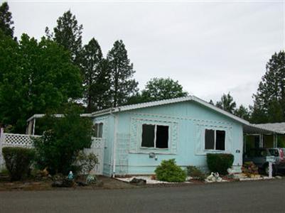 What a sweet deal on this updated 1991 home in Shady Cove 55+ park close to grocery & post office. Newer laminate floors in living rm., dining rm., hall, kit., utility & newer vinyl in 2 baths. There is also a wonderful near new pellet stove & nice cellular shades t/o. Open kit. has snack bar, lg. sideXside ref.& built-in desk. M/bdrm has walk-in closet & 60 shower in bath. You will love the yd. with covered deck, new vinyl front fence & new wood rear fence. There is also a 10X16 shop/shed with cabinets & shelves. Home warranty included. Possible owner carry with good down.