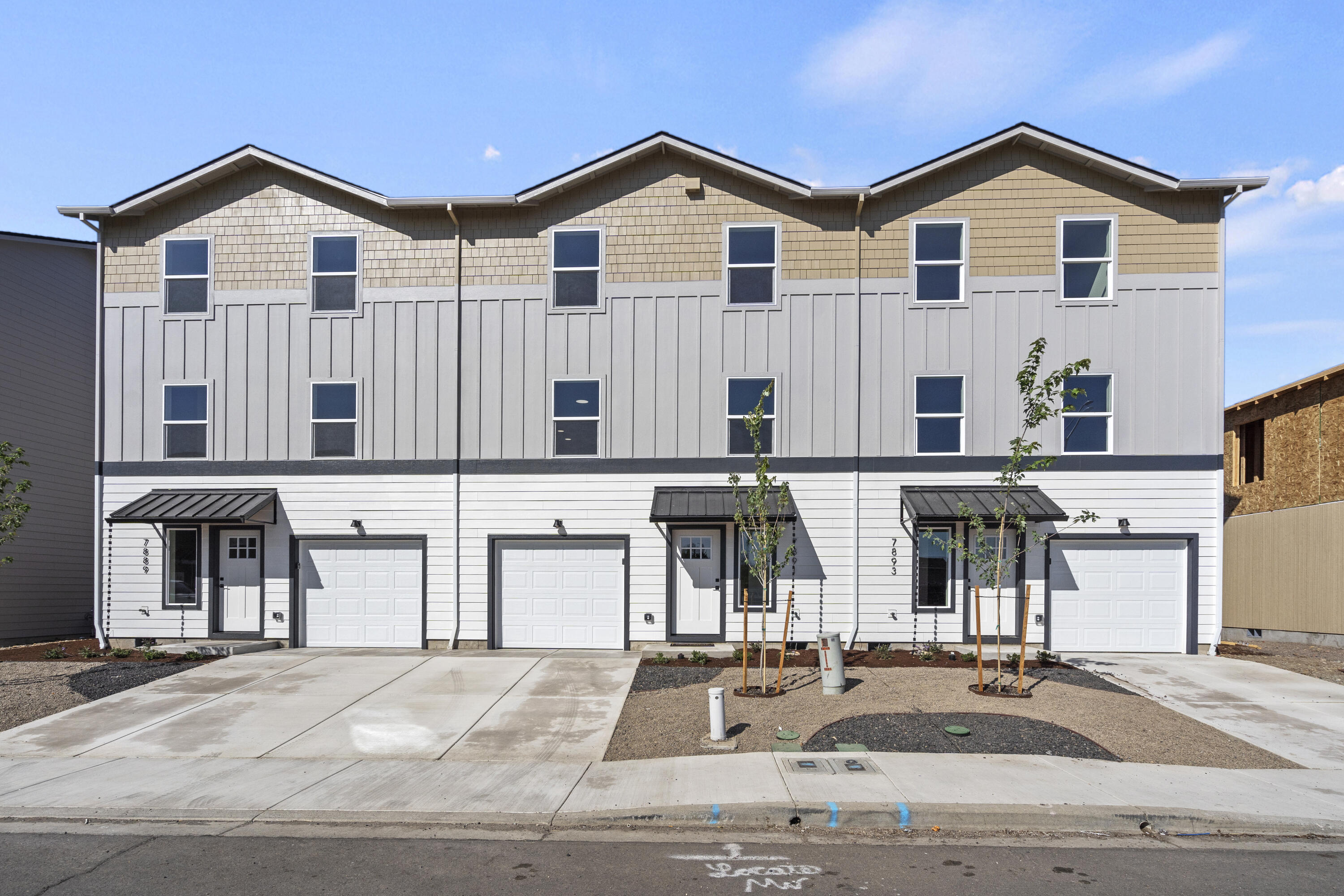 Step into contemporary elegance with this stunning new townhome by Olaf & Company, LLC. This move-in-ready residence offers 1,363 sq. ft. of modern living space. It features three bedrooms, including a convenient ground-floor bedroom, and two luxurious upper-floor bedrooms with their own ensuites, providing both comfort and privacy. The middle floor boasts a spacious kitchen with granite countertops and upgraded cabinets, ideal for culinary enthusiasts. The open-concept living and dining areas are designed for both relaxation and entertaining. The upper floor includes washer and dryer hookups for added convenience. Enjoy breathtaking views from the top floors and benefit from additional features such as an oversized single-car garage, a fully fenced backyard, Milgard windows, and 100% Hardie Siding. Practical entry area storage enhances functionality. An Energy Performance Score will be provided upon completion. One of only three left, come get it before it's gone!