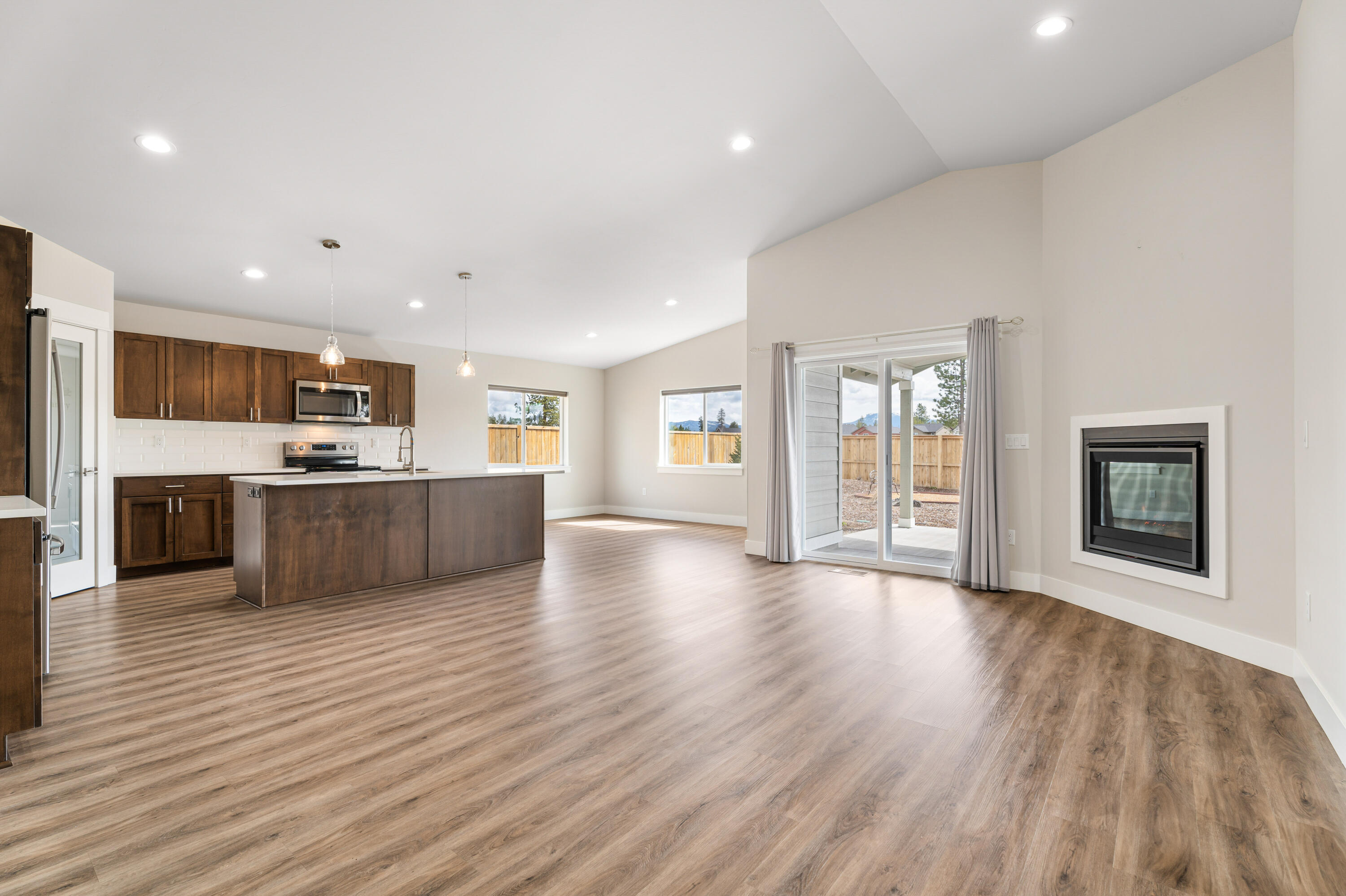 This large .22 acres corner lot is fully fenced and backs up to open space. The 3-4 bedroom home with office has been lightly lived in by it's out of state owners, and it is the one with the builder upgrades! These meticulous owners added A/C, custom blinds on all the windows, it has a 4 zone watering system in front and back with professional landscaping. The gas fireplace in the main living space adds a perfect ambience to enjoy space highlighted by the vaulted ceilings. The chef's kitchen is built around a gorgeous island and an off-set dining room that offers views and access to the back yard with a huge covered porch offering a perfect place for entertaining and relaxing. The Reserve at the Pines is quickly becoming La Pine's sought after neighborhood with its convenient location and very chill vibe. This home is simply bigger and better for so many reasons - it's a must see!!