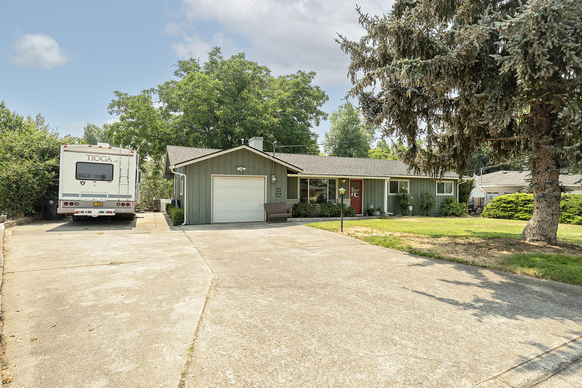 This beautifully remodeled 1959 East Medford home offers single-story living on a spacious .38-acre lot. With 2,013 sq. ft. It features 4 bedrooms and 2.5 baths. The kitchen, updated(2017), boasts new stainless steel appliances, five burner gas stove, quartz counter tops and built in microwave complementing the modernized feel. Recent upgrades include a new hot water heater, HVAC (2022), and an updated electrical panel (2021). The home has double-pane windows, a mix of real oak hardwood and newer carpet, ensuring comfort and style throughout. Outside, enjoy a large, private backyard with a park-like setting, perfect for activities and entertaining, plus RV parking and creek frontage. A perfect blend of classic charm and modern convenience! RV hook up power no dump. View of the creek.