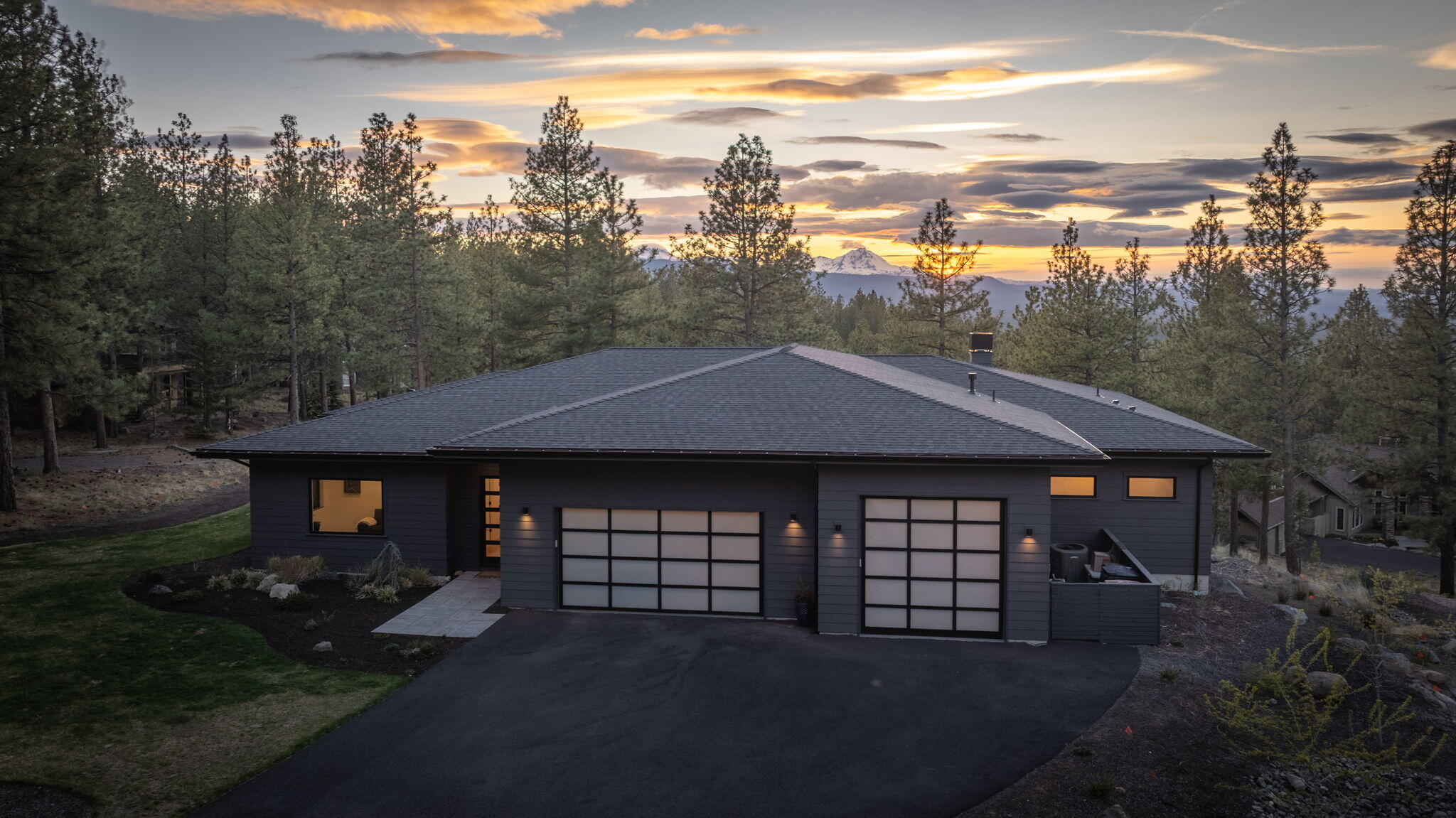 Perched atop Awbrey Butte's desirable west flank, this stunning NW contemporary newer construction is bathed in natural light, offering welcoming spaces and exquisite interior details. Single-level living ''done to the nines''. The residence boasts an expansive west-facing deck with a custom fire pit, framing breathtaking Cascade Mountain vistas. Inside, 10' ceilings enhance the light-filled ambiance, centered around a magnificent great room and an expansive kitchen showcasing quartz countertops and Thermador appliances. The primary bedroom suite, privately situated on the north end, offers a serene retreat. 3 additional guest bedrooms are thoughtfully nestled in the south wing, providing privacy and comfort and are complemented by a media room. A large walk-in pantry, a well-appointed laundry room, and abundant storage solutions throughout. The generous 971 sq ft, 3-car garage features an oversized Sprinter bay with 12' ceilings, custom cabinets, epoxy floors. Truly an exceptional home