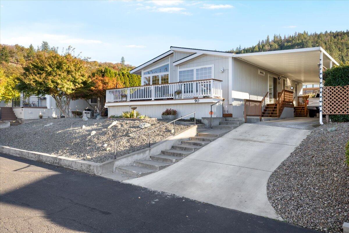 Welcome to this beautifully remodeled 2-bedroom, 2-bathroom home with breathtaking views in Western Carriage Estates, a quiet, well-maintained 55+ park perfectly positioned between Medford and Jacksonville. This residence has been meticulously remodeled inside and out with extensive renovations that show in every detail including new appliances. The inviting living room flows into a versatile bonus room. The kitchen features a convenient double oven, and a dedicated laundry room adds everyday functionality. Relax by the seasonal pool and enjoy use of the clubhouse. Schedule a tour today!