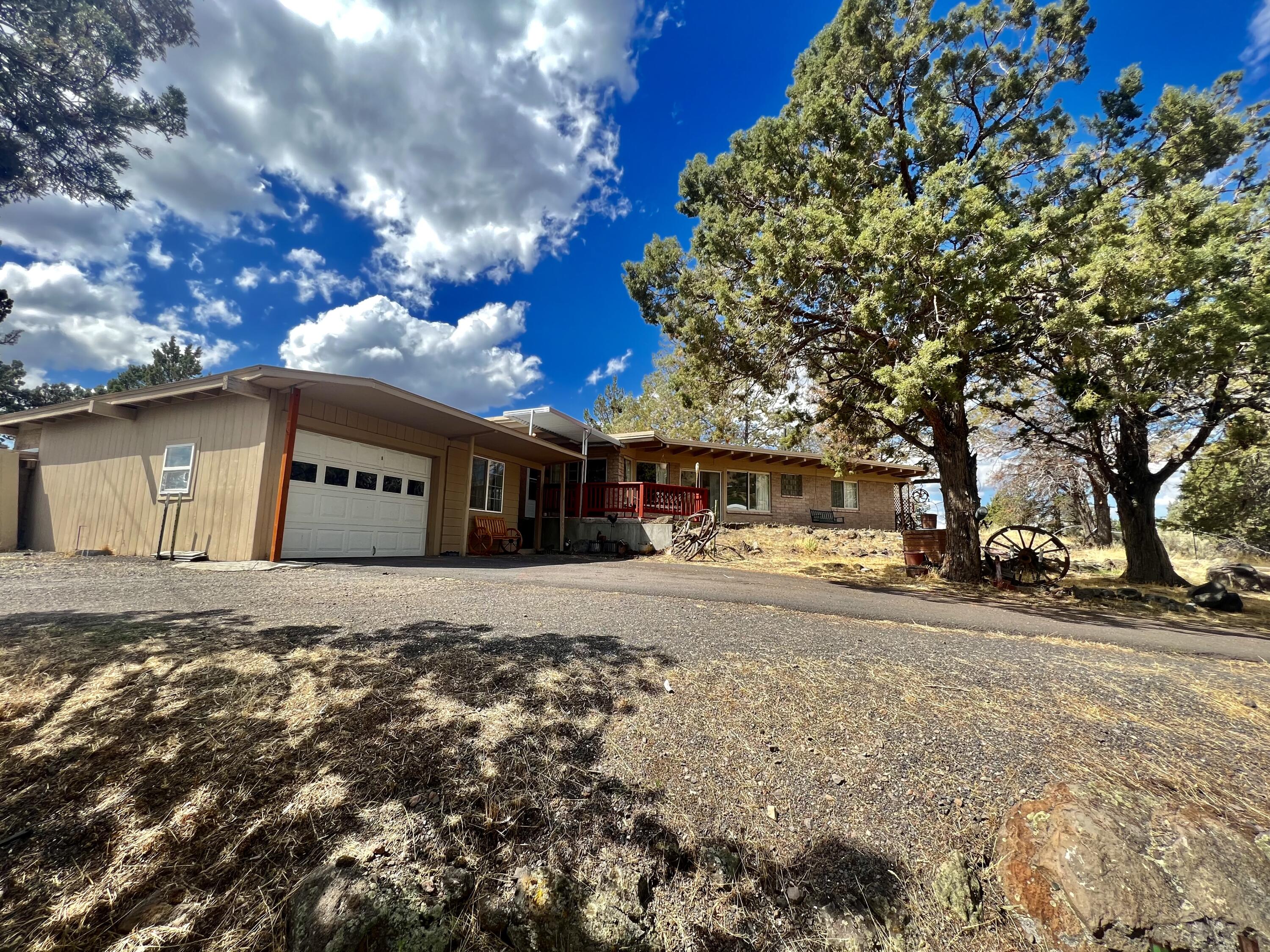 This charming house, constructed in 1957, features a unique open-plan layout, showcasing striking exposed beams. The back deck boasts stunning views of the Klamath Basin, adding to the charm of the property. The house includes two cozy bedrooms, a bathroom, and a bonus room that has its own separate entrance. On top of that, you can make use of a one-car garage and a roomy two-bay workshop for your convenience. The wraparound driveway provides ample parking space for your vehicles. Make your appointment today!