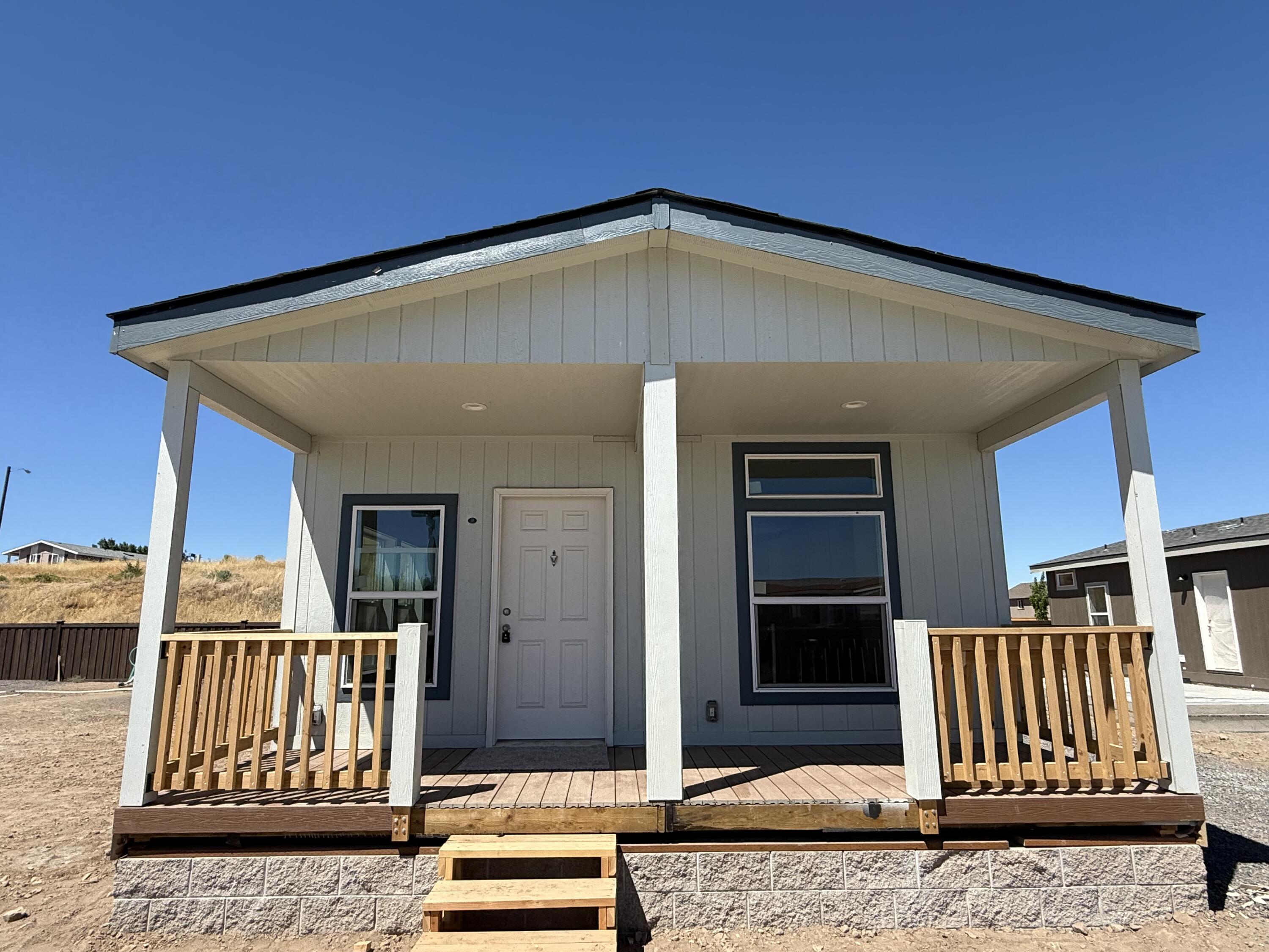 Welcome to Summer Place, Madras's newest gated manufactured home community  just minutes from downtown and local dining.
This brand-new 3-bedroom, 2-bath home offers 1,023 square feet of well-designed living space. The exterior features pearl gray paint with slate tile trim and an estate gray roof for modern curb appeal. Inside, alabaster paint creates a bright, neutral backdrop. The kitchen boasts knotty cabinets, Bello Romano counters, and a full arctic ceramic tile backsplash, while the bathrooms feature aluma marble counters with matching backsplash. Flooring includes westwood vinyl in main areas, with oxford carpet in bedrooms and living room. Stainless steel appliances, a built-in microwave and dishwasher, andA 6-foot front porch, 1-car attached garage, and paved double-wide driveway complete the package. Space rent ranges from $595 to $650/month, with purchase options available for custom order. Call EXIT Realty Today!