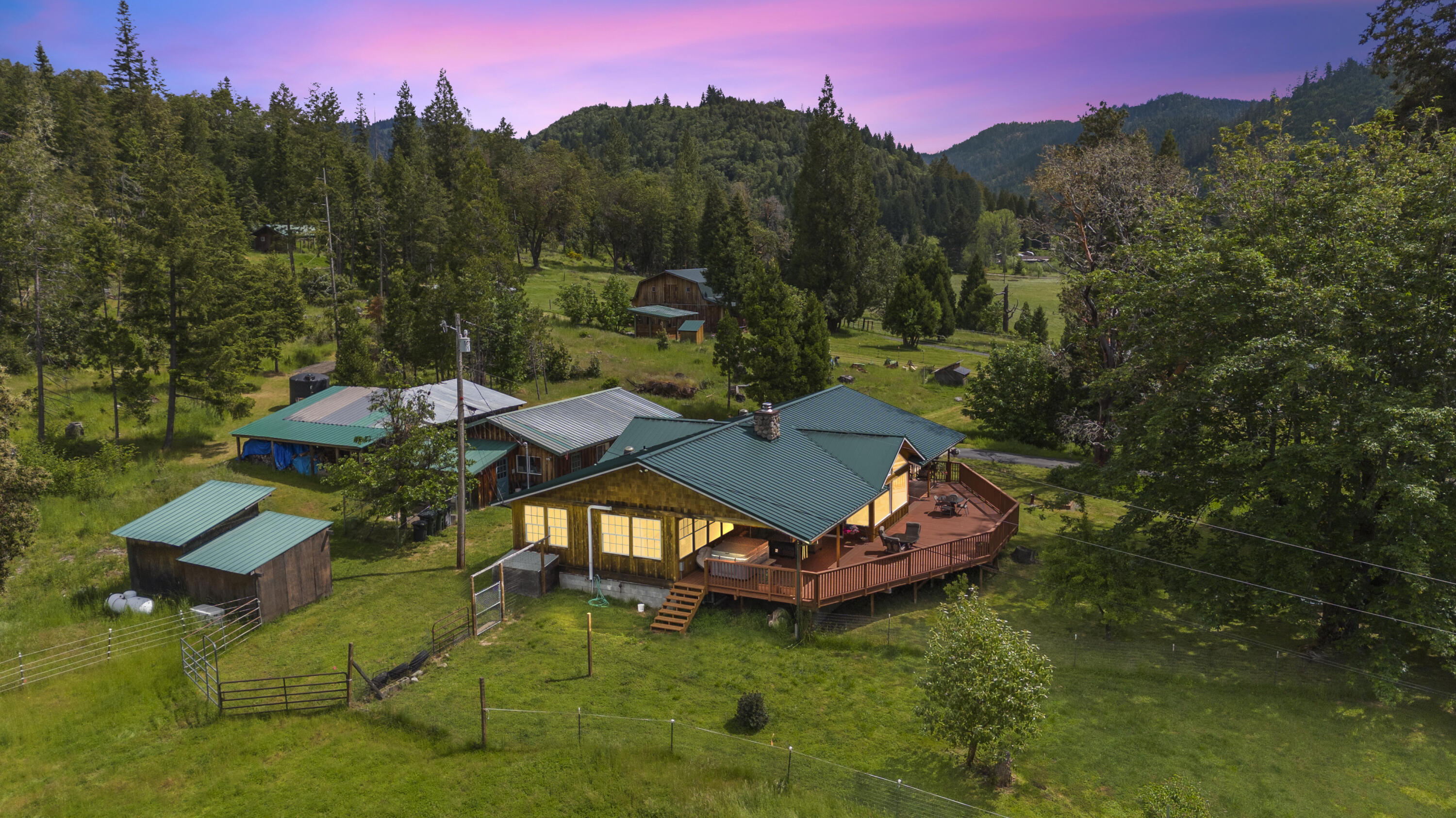 Best Equestrian Property in Southern Oregon:  68x144' Covered arena w/ 11 stalls & turnouts, wash rack with hot water, and multiple pastures to ensure your horses have room to roam. Hay storage, insulated tack room with living quarters above arena or use for announcer's booth.  Multiple out buildings for equipment storage & shop. Feeder barn and additional barn with 3 stalls, tack room, turnouts and pasture. Your own hay field & 50 acres of irrigation rights. 2 RV full hookups. This home offers open living space.  Kitchen includes double ovens, island with pot filler, farm sink, ample storage, granite counters and a breakfast bar. There is a deck/covered living space off front of home to enjoy the sunrises and sunsets.  Primary suite has large walk-in closet, dual vanity and shower.  2 more nicely sized  bedrooms on other side of living space and guest bath. Main house has a Generac and SOLAR! Self efficiency abounds here.   Additional Homesite/Address is at property as well