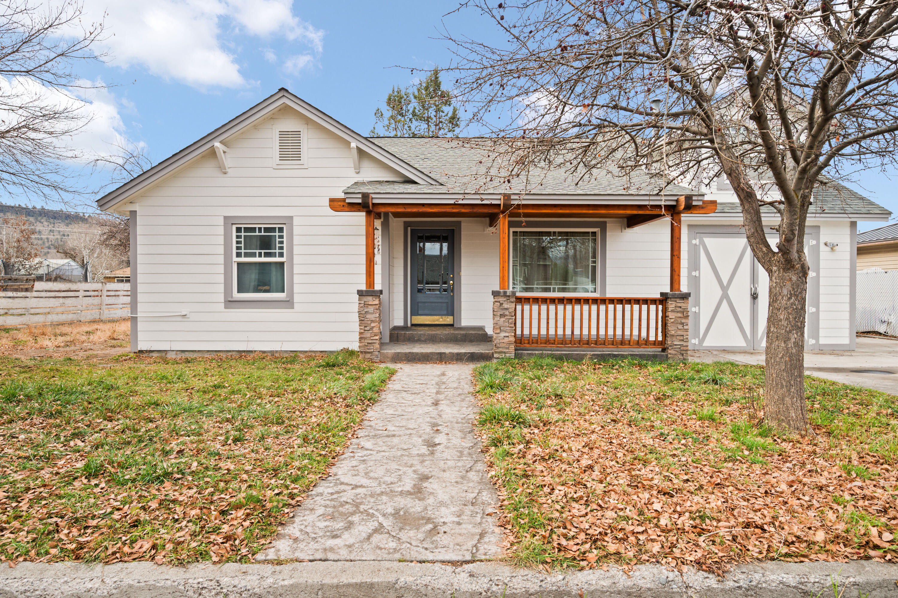 Welcome to this updated Craftsman-style home in one of Prineville's most desirable neighborhoods. With 5 bedrooms, 2 bathrooms, and nearly 2,500 sq ft, it blends classic character with modern upgrades. Inside, you'll find original built-ins, arched doorways, and great natural light. The main level includes two bedrooms, a full bath, a spacious living room, open kitchen, family room, and laundry area. Upstairs, the large primary suite offers generous space, great light, and an updated en suite bath. Over $40,000 in recent improvements include interior and exterior paint, laminate flooring, and custom tile showers. Set on a 0.20-acre lot with alley access, the home also features a covered patio ideal for relaxing or entertaining. Close to schools, parks, and local amenities, this property offers comfort, convenience, and the welcoming small-town lifestyle Prineville is known for.