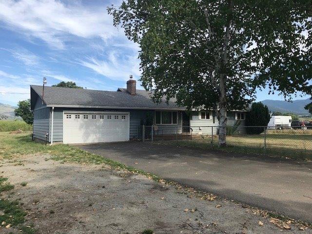 This pleasant country charmer has TID irrigation that can be used for those 4 H projects, or you can just green up the surrounding grounds and entertain family and friends. Large conifer shade trees line about half the property, and the other half is flat and open with lots of sun exposure. There are some small outbuildings and property is mostly fenced. Big 2 car attached garage. This home offers any family opportunity for living on small acreage. The home is a one level layout and partially floored with hardwood. Master bath has been updated. From the cabinet studded kitchen an addition was added which can be used multi-purposely as family/Rec or dining room. To bring this home to its glory days you need to bring a little love. Country settings on small acreage like this doesn't last long.
