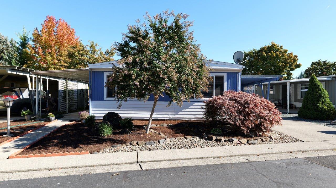 Modern luxury at an affordable price. Extensively remodeled 2-bdrm, 2-bath home w/over 1,200-sq. ft.  is located in the 55+ community at Aspens on the Creek. You will not find a more luxurious, upgraded, tastefully remolded home around.  The spacious open floor plan provides a comfortable feel while allowing tons of natural light throughout.  All upgrades have been done in the past year. Exterior boasts a wonderful covered patio, new outside paint, nice sized carport, 2-sizeable sheds & newly done low maintenance landscaping. Inside boasts an all-new kitchen w/custom soft close cabinets, Quartz countertops, LG Think Q Stainless appliances, farm house sink & more.  Both bathrooms have been redone & the primary suite has a spacious walk-in closet w/built ins. You won't believe the attention to detail w/custom features throughout including luxury carpet w/memory foam padding, custom ceilings, fixtures, high end LVP flooring & more. Space rent is super affordable @ only $675/mo.