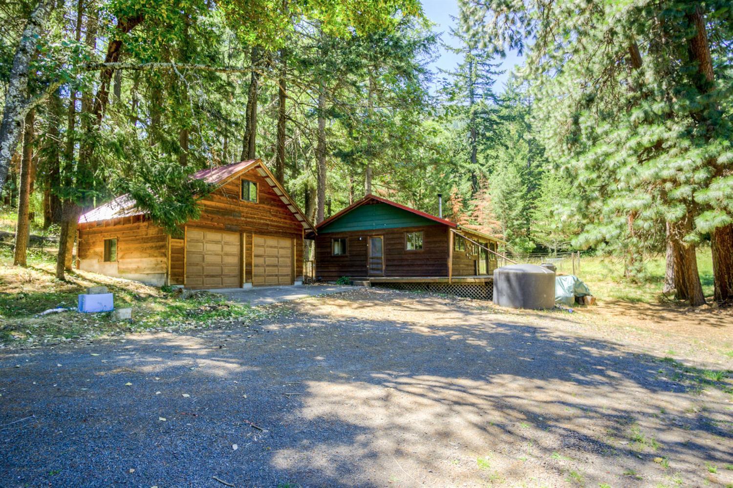 Secluded mountain living near skiing, lakes, hiking trails and still just a short drive to downtown Ashland. This cozy mountain cabin sits on nearly 5 acres of beautifully wooded and open pasture land. This sunny and light and bright home has an open floor plan with a large open kitchen, mini-split ductless heating and cooling system, rain water catchment, a huge oversize deck overlooking the pasture and a detached two car garage with a large loft for additional living space or storage. This private retreat in the woods is perfect for those seeking a rural and private home without being far from all that Ashland has to offer.