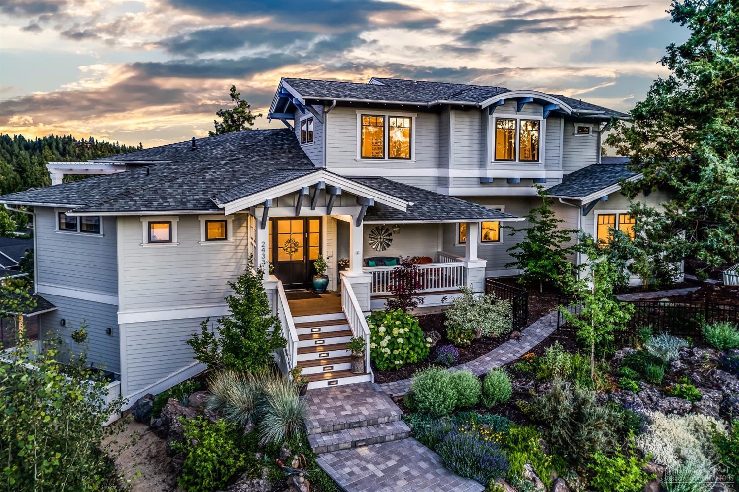 Stunning, one of a kind custom home on a large lot in NW Crossing. Over 1200 Sq Ft of deck, heated driveway and supplemental solar system. An entertainer's dream kitchen featuring honed granite counter-tops and a grand butcher block topped island. Bright and open floor plan with master suite and a junior master suite on the main level. Handsome hardwood floors, high ceilings, and massive windows. Vast storage and built-ins and a lower level office/mother-in-law suite with full bathroom and private entrance.