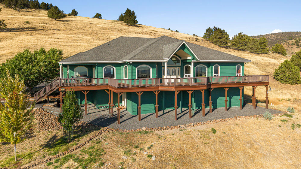 Absolutely incredible property, breathtaking views & upgrades galore! What an opportunity as this home has never been on the market before! Single story, fully ADA accessible with a dual primary bedroom setup. All bedrooms have their own bathrooms and walk in closets. Beautiful hardwood flooring throughout the main living area, a formal dining room that is open to the great room featuring views of the town and Mt Shasta. Kitchen has 2 islands, 2 sinks, granite counters, 3 ovens, custom cabinetry, with an open concept and a nearby wet bar. Kitchen and living space are perfect for entertaining and gatherings. Next to the large living room is a bonus theater room with a projector and screen. All guest showers were recently refinished with cultured marble surrounds. Private immaculate backyard with landscaping. Enjoy the covered outdoor BBQ area with a large ducting vent hood. There is space beneath the house with tall ceilings for more possible square footage as well! Truly one of a kind