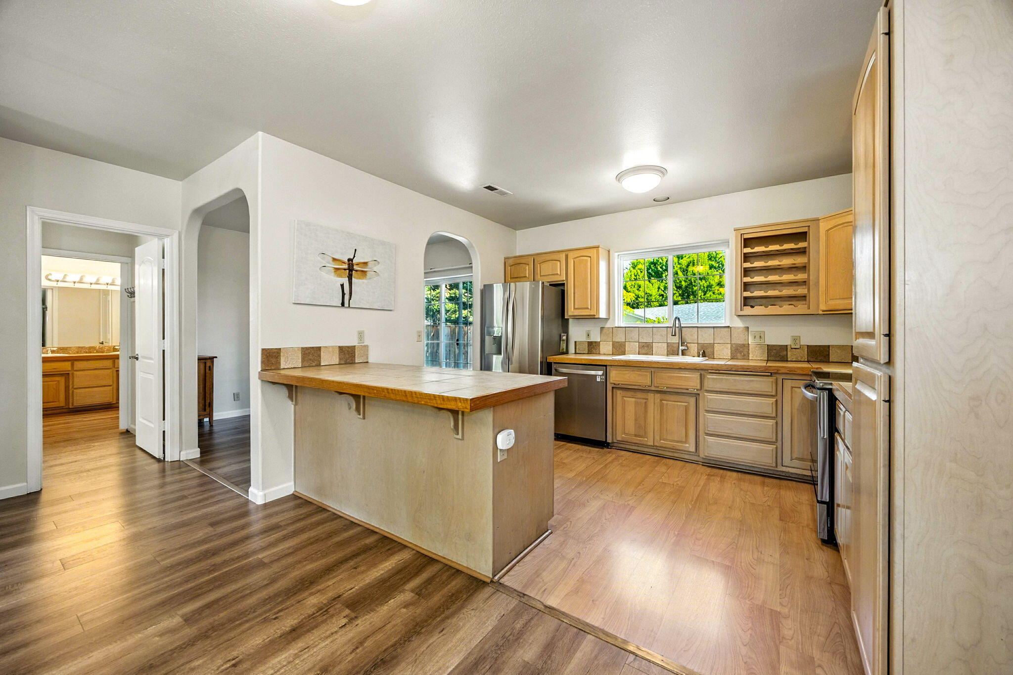 Tucked away on a private flag lot across from Bellview School, this well-cared-for home offers rare peace and quiet while staying close to hiking trails, shopping, and restaurants. Set back from the main drive, it features a split, open floor plan that feels spacious and inviting. Thoughtful upgrades include all-new stainless steel appliances, new landscaping with drip irrigation, and exterior paint in 2021. Interior paint and flooring were refreshed in 2018, and a new roof was added in 2016. The generous kitchen flows into an open living area, while the main bedroom offers a cozy 4x6 bay window seat and en-suite with dual vanities and marble-surround tub/shower. Sitting on a flat lot with mature trees, this home is in great condition and blends comfort, privacy, and convenience.
