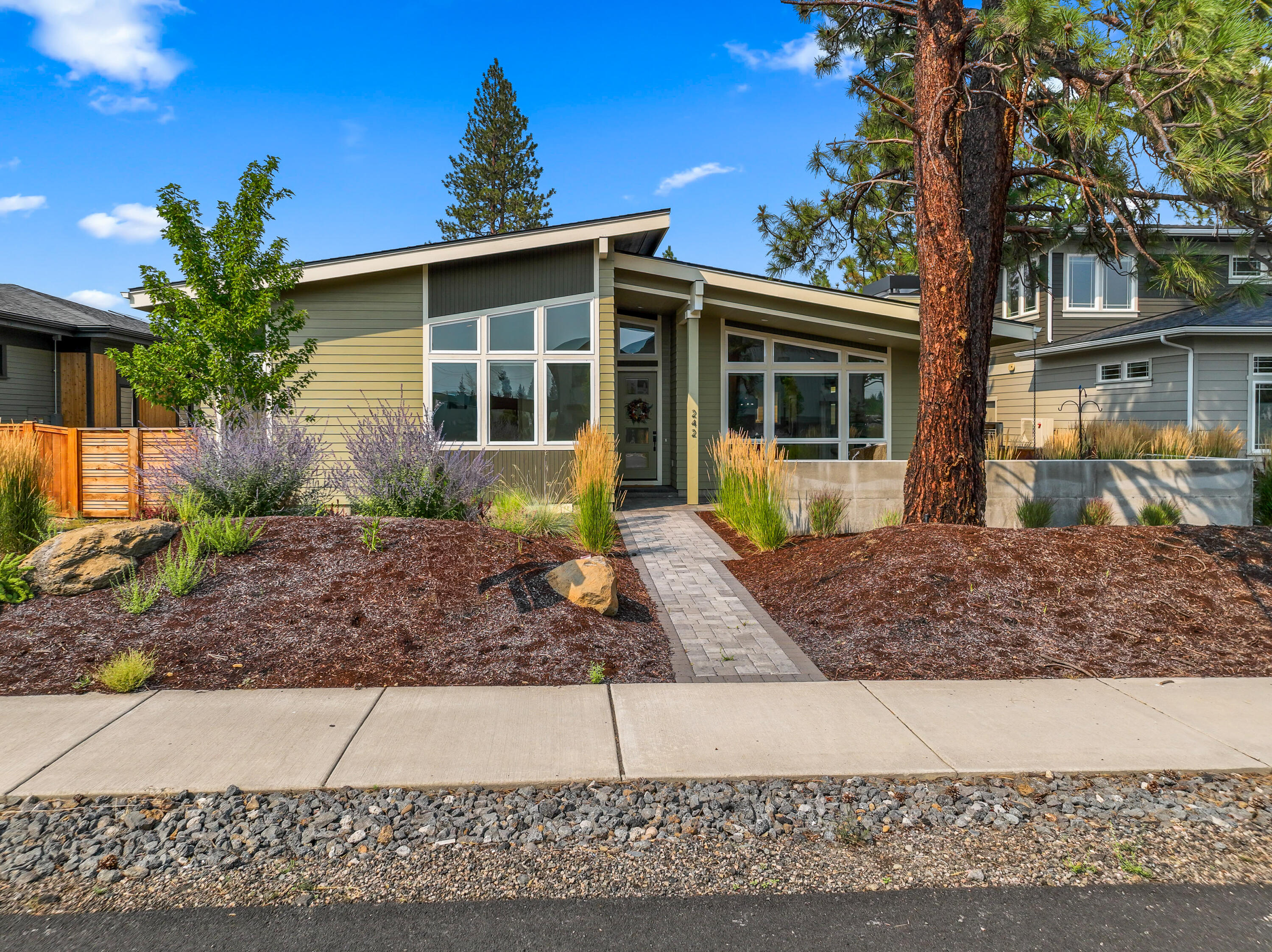 Beautifully crafted single-level mid-century modern home offering 1,972 SqFt of stylish, open-concept living in the heart of Sisters. The great room features vaulted ceilings and abundant natural light, flowing seamlessly into the dining area and gourmet kitchen with custom cabinetry, high-end appliances, and a full-height tile backsplash. The luxurious primary suite includes a spacious walk-in closet with built-ins and a spa-like bath with walk-in tile shower and dual vanities. Two additional bedrooms, a full bath, laundry/mudroom, and attached two-car garage complete the home. Located in the sought-after ClearPine community with access to trails, a neighborhood park, local coffee shops, and just minutes from downtown Sisters. Welcome to the best of Central Oregon living!