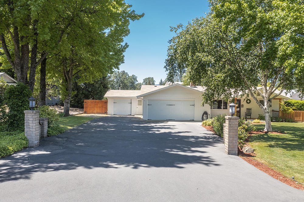 Enjoy Grants Pass the way it was meant to be enjoyed with this completely remodeled, updated home on a .53 acre lot.  Experience the best of both worlds with fresh well water, deeded river access, and city sewer, as well as District 7 Schools.  This GPID-irrigated property has room for the hobby farm feel while being close to city services.  The well designed home has generously sized living and dining rooms and boasts a fully remodeled kitchen that features quartz countertops, six-burner gas stove, hammered copper sink, and wet bar with built-in wine fridge.  Attached two car garage along with attached single car shop with guest room is a wonderful compliment to this beautiful, easy living home.  Backyard is fully fenced and cross-fenced with an adorable playhouse style cottage.  Come check out this truly unique property for yourself!