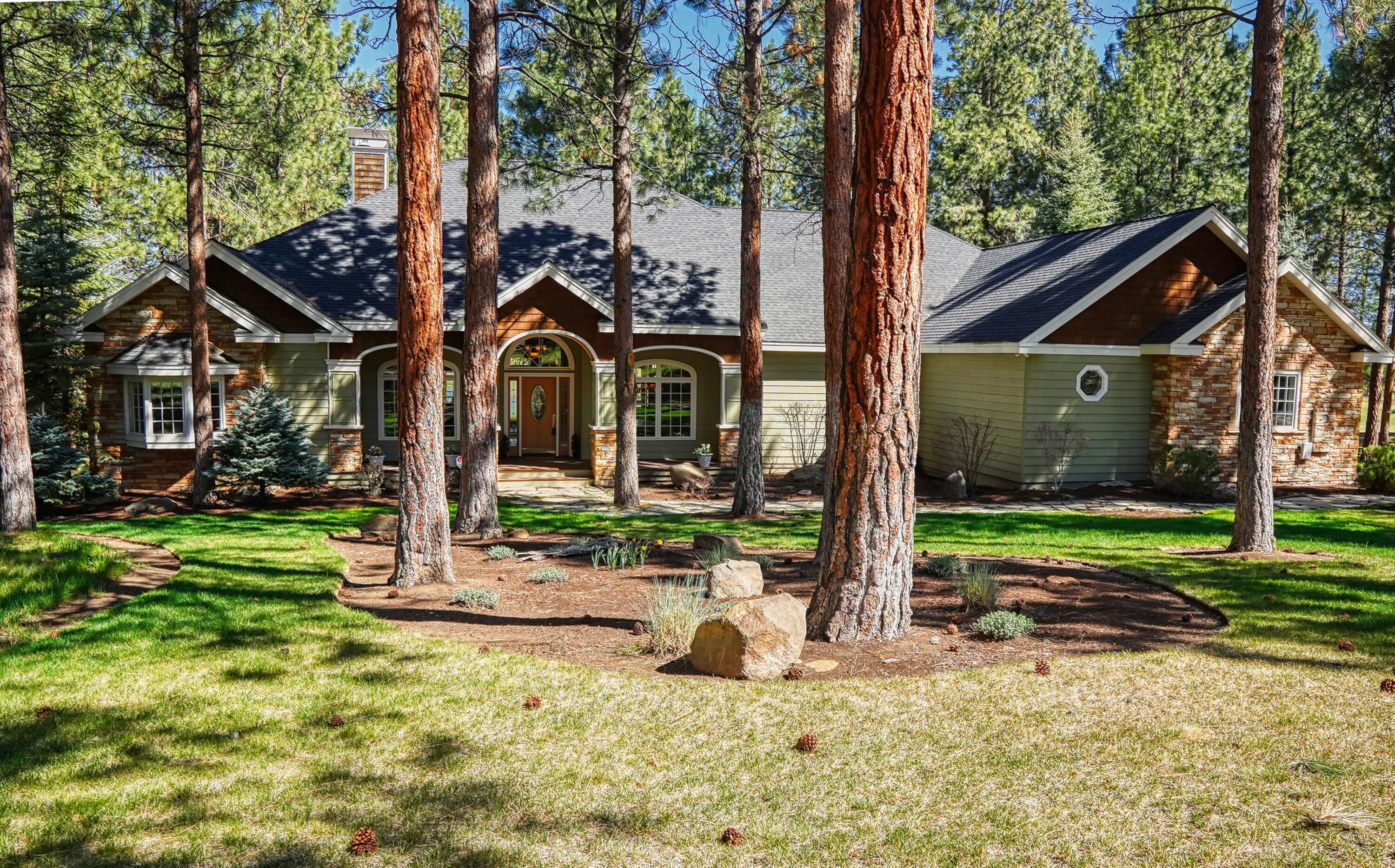 Soaring eagles, osprey diving for trout and a preening swan are the sights awaiting you from this custom designed Aspen Lake Golf Estates home. Designed to take advantage of the peaceful lake view, you will love the privacy and you will appreciate the construction by Craig Johannessen. Entire home is single-level living (other than loft looking into great room). Private, separated master with fireplace plus two private guest wing suites. Well-thought-out floor plan with wonderful finishes and upgrades such as knotty Alder cabinetry, Thermador six burner propane with griddle, 2020 built-in Jennair fridge, warm wood floors and beautiful wood ceiling, eight foot solid doors and huge mahogany deck with ironwood railing. Finished garage, approx. 955 sq.ft. This well-priced quality home on a pine studded acre in our favorite award-winning golf community challenges comparison! You will LOVE living here, even if you are not a golfer!