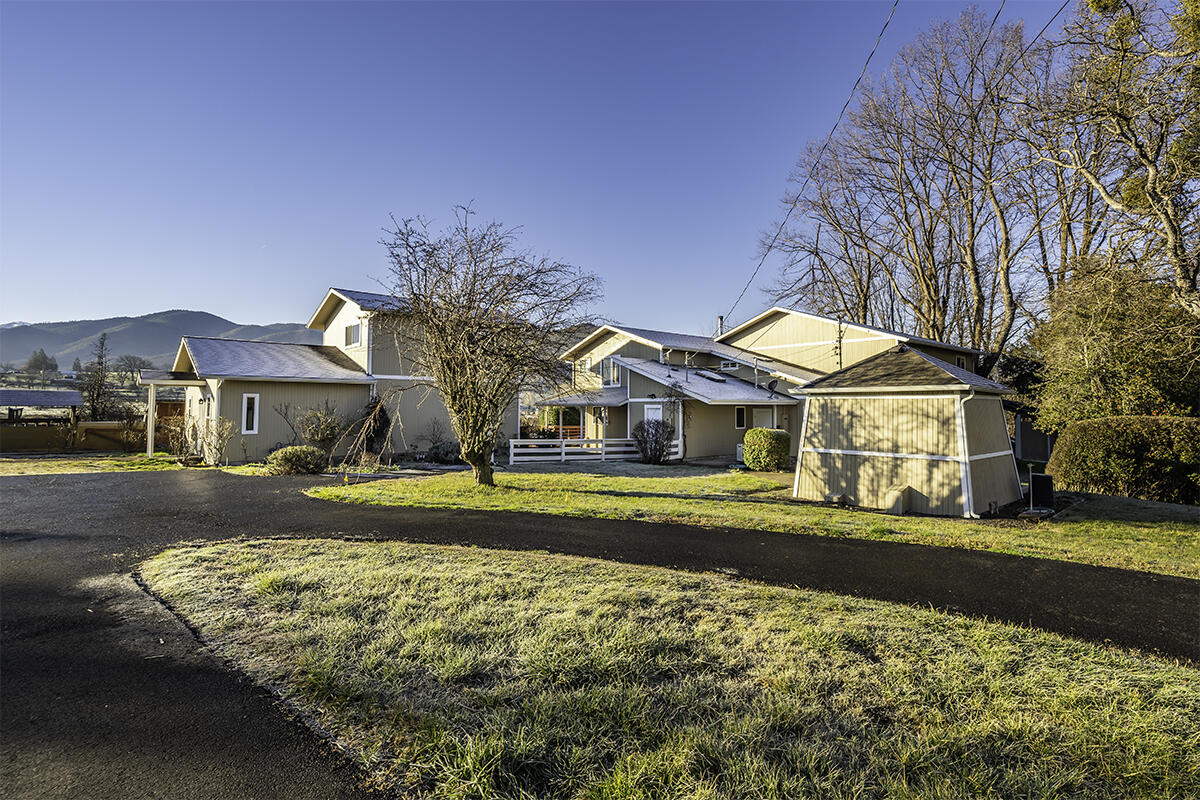 Fabulous rural Ashland view property on 10 level irrigated acres with mountain views. This property offers so much!  Enjoy close in Ashland living and your privacy too! Truly a great property with large main home, guest house, pool house, inground pool, 5 car garage and workshops. The main home is large with 3207 sq ft, freshly painted interior, expansive main living areas, soaring cathedral ceilings, hardwood flooring, chef's kitchen with dining bar, large dining room, 5 bedrooms and 2 ½ baths. Main living area overlooks the inground pool and entertainment decking. Separate pool house with full bath. Separate 2-story guest house is 1341 sq ft with open main living area, full bath, upper large bedroom with ½ bath and view balcony. There is a 5-car garage with 2 extra workrooms. Huge old barn and chicken coop.