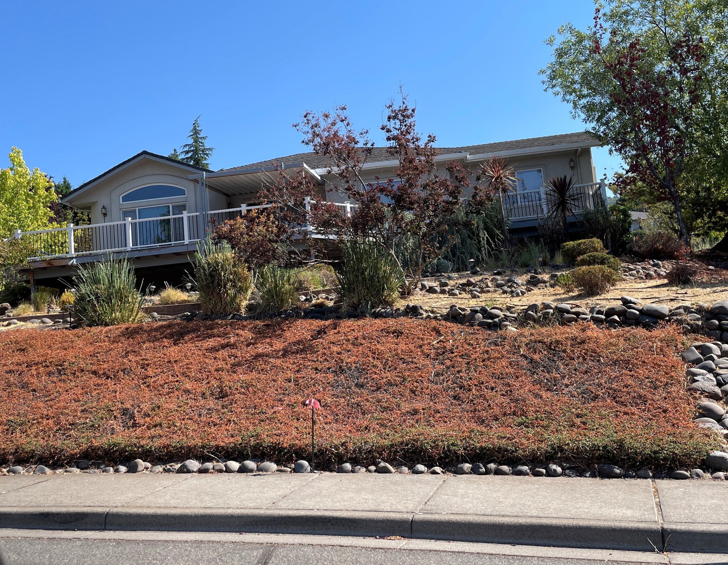 .34 Acre lot located on landscaped corner lot with views of mountains, valley, Mt Ashland, sparkling lights of the city. Updated kitchen with granite countertops, lots of built in storage. Top of the line appliances. Hardwood floors throughout. wrap around deck. over size 2 car garage. two primary bedrooms and bathrooms, powder room. large walk in closet, family room w/built ins for tb and book case. RV space, huge under house storage shed.