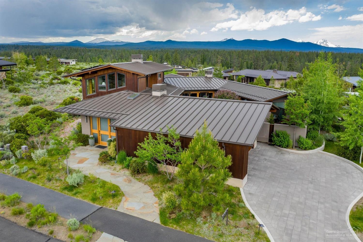 NW Contemporary provides Old World charm reminiscent of a Mediterranean villa. The U-shaped custom surrounds a fully enclosed courtyard making it the meditative heart of the home. Efficiency of space is evident in a wall of built-ins where a powder is neatly tucked away & a sitting area faces the Cascades. In the great room, a long wall of glass sliders opens onto the main courtyard, while more glass doors & walls of windows on the opposite, west side of the home allow the Cascades & sun to wash in. Find natural accents like a recycled barn beam hearth & a mix of honed granite & quartz in a chef's kitchen. Main level master features built-in settee facing courtyard & pvt entrance to a sunroom. Offering a space to relax & rejuvenate year-round, sunroom provides a covered space w/heater above & accordion glass doors opening to the courtyard. Upstairs: 2 more bedrooms & a full bath. 1st room faces territorial views to the east. 2nd room offers another flexible space w/ gas FP & built-ins.