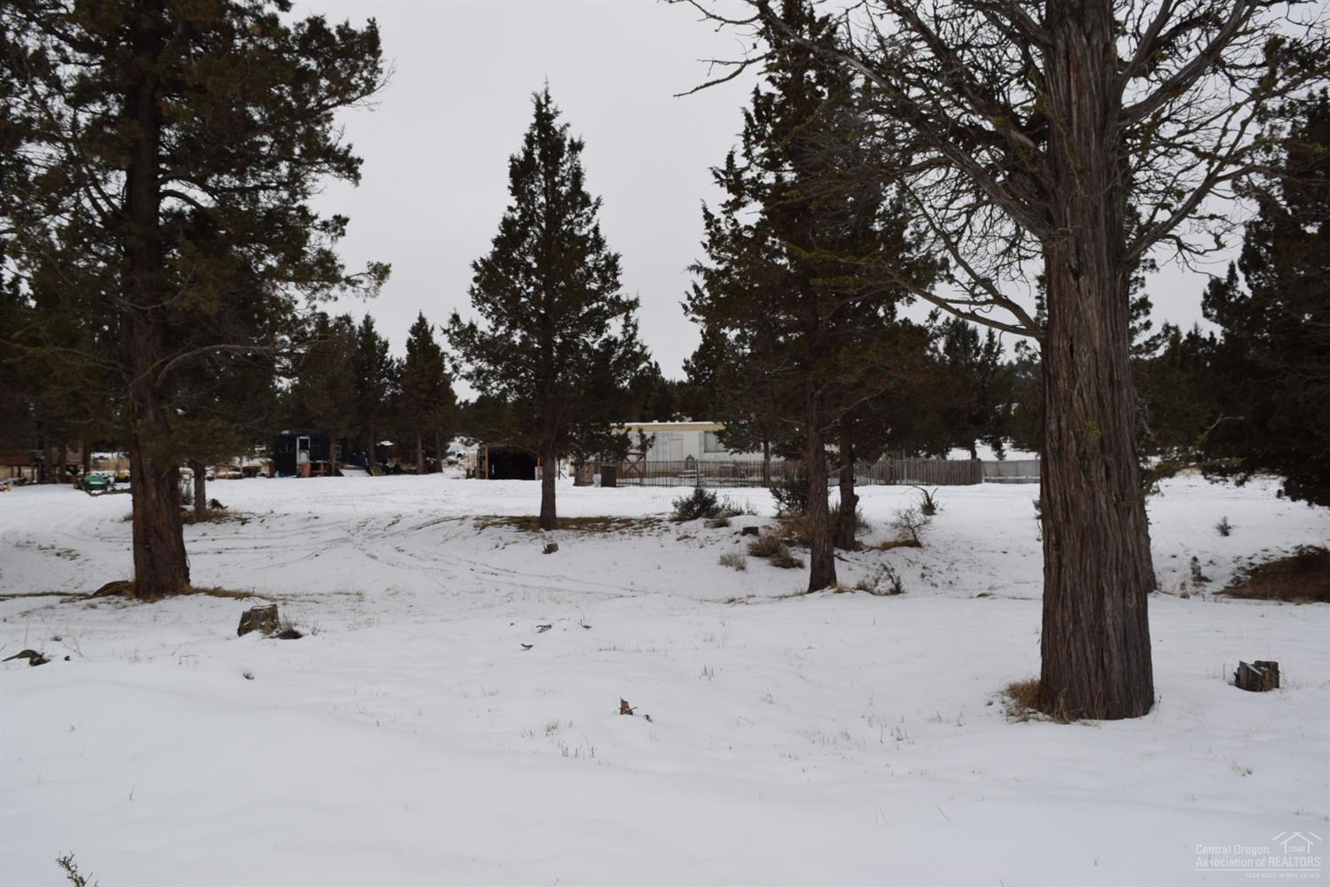 Nice starter place with a couple of acres for outdoor fun. Enjoy foothills view from the single wide with 2 bedrooms, 1 bath, and upgraded kitchen cabinets. Nice woodstove to keep warm with in the colder Winter months. Includes a storage building and a portable cover for a vehicle. Fenced front yard. Best part is the Owner Carry Contract option. Preferably $20K down, payments over 10 years at 5 percent interest.