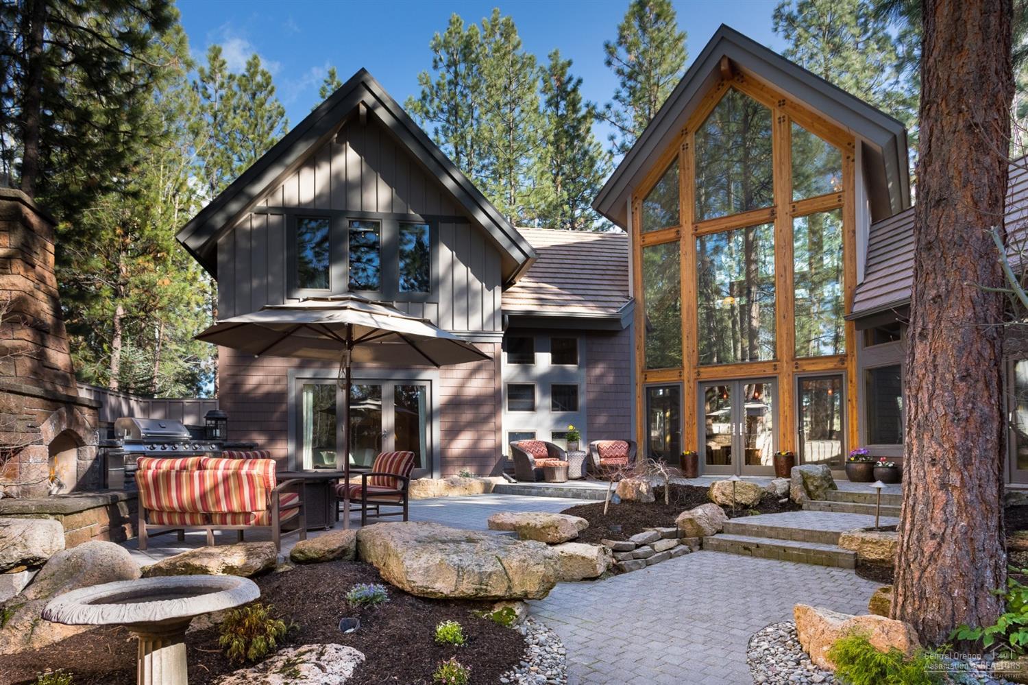 Nestled above Broken Top's Signature Fairway, this spectacular home is a sophisticated blend of NW & Contemporary custom architecture that surrounds you in luxury from every angle, yet allows you to live in a casual environment. Custom wood-carved Cougar entry gate open to 1600/sq.ft. outdoor living paradise featuring private courtyard, gas fireplace, BBQ and refrigerator. This home features incredible flowing floorplan, spacious open living with Gourmet Island kitchen/Jenn-Aire and sub-zero appliances, stunning radiant heated Indiana Limestone Floors/staircase, vaulted beamed ceilings in every room with wood-case Andersen windows throughout strategically placed with french doors that bring the outdoors in. Private Master-suite retreat & loft/office/den, formal dining and 2 bonus rooms would be ideal theater or guest suite. Very private lot with a natural blend of outdoor and indoor living. Attached and detached garages offer 4-car garage w/flex space/bonus room above.