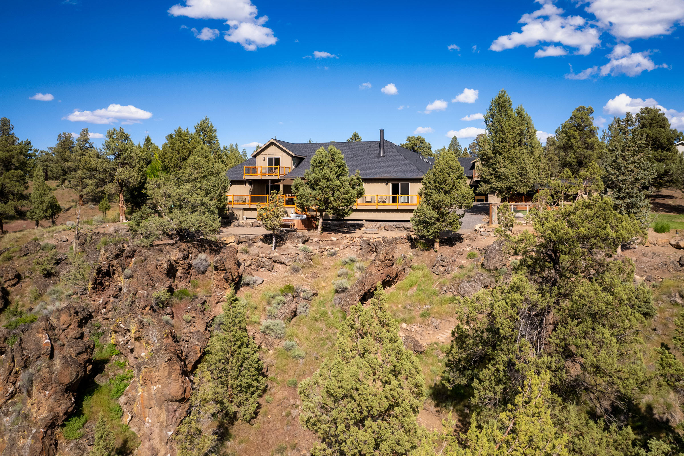 Single level living on the bank of the Deschutes River in the desirable gated Odin Falls Ranch community in NW Redmond. This 2.5 acre parcel has outstanding river views, frontage and fishable trailside access as good as it gets anywhere in Central Oregon. This home's high quality finishes shine throughout with updated flooring, lighting and appliances. The original owners have kept meticulous care of the place that was designed for large family gatherings and fun activities. All bedrooms and kitchen are on the main floor, with an office and bonus room adding 2nd level space. The Cascades and river are viewable throughout and most easily taken from the paver patio, hot tub, deck or gaming lawn. The 1512 (54'x28') sq. ft. shop directly off the 3 car garage is large enough for most RVs, with room left over for a bar, shuffleboard area, workshop space, bathroom & upstairs finished bonus room. Additional outbuildings and storage throughout. A true must see! Make your appointment today.