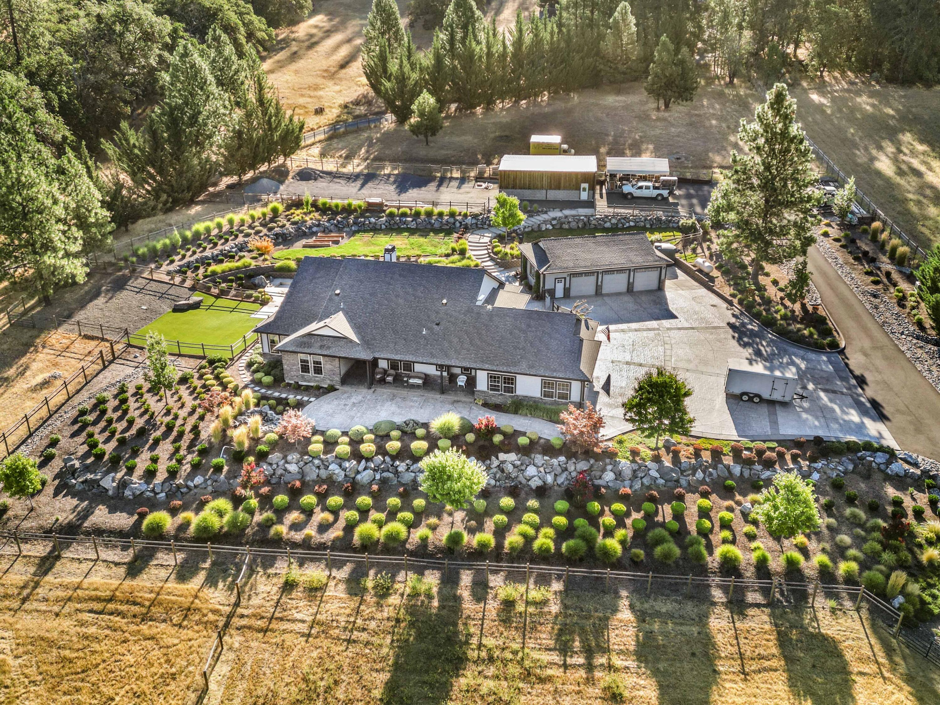 Luxurious living in captivating country. Minutes from the Famous Rogue River, this upscale modern home is a Dream! Gourmet kitchen, with top-of-the-line appliances, double ovens, pull outs, quartzite, & amazing pantry. Vaulted ceilings and radiant heated floors throughout. Enjoy the stunning fireplace and upscale beautiful wet bar. Low maintenance, built for comfortable Classy Living, horses, cars or just enjoying the views. Secluded, spacious and gorgeous make this property the ideal place for a family or professionals. Gentlemans Shop or ADU. Close to1200 sq ft- with full bathroom, kitchenette and storage. Large, insulated Horse barn includes all gates and plenty of power on this property for car lifts or agriculture. Equestrian property is fenced and cross fenced with several different areas for ease. Gated entry, clean water, great well, beautiful landscaping, custom backyard and Japanese soaking tub. Efficient, Stunning, First-Class living. Call & visit anytime.