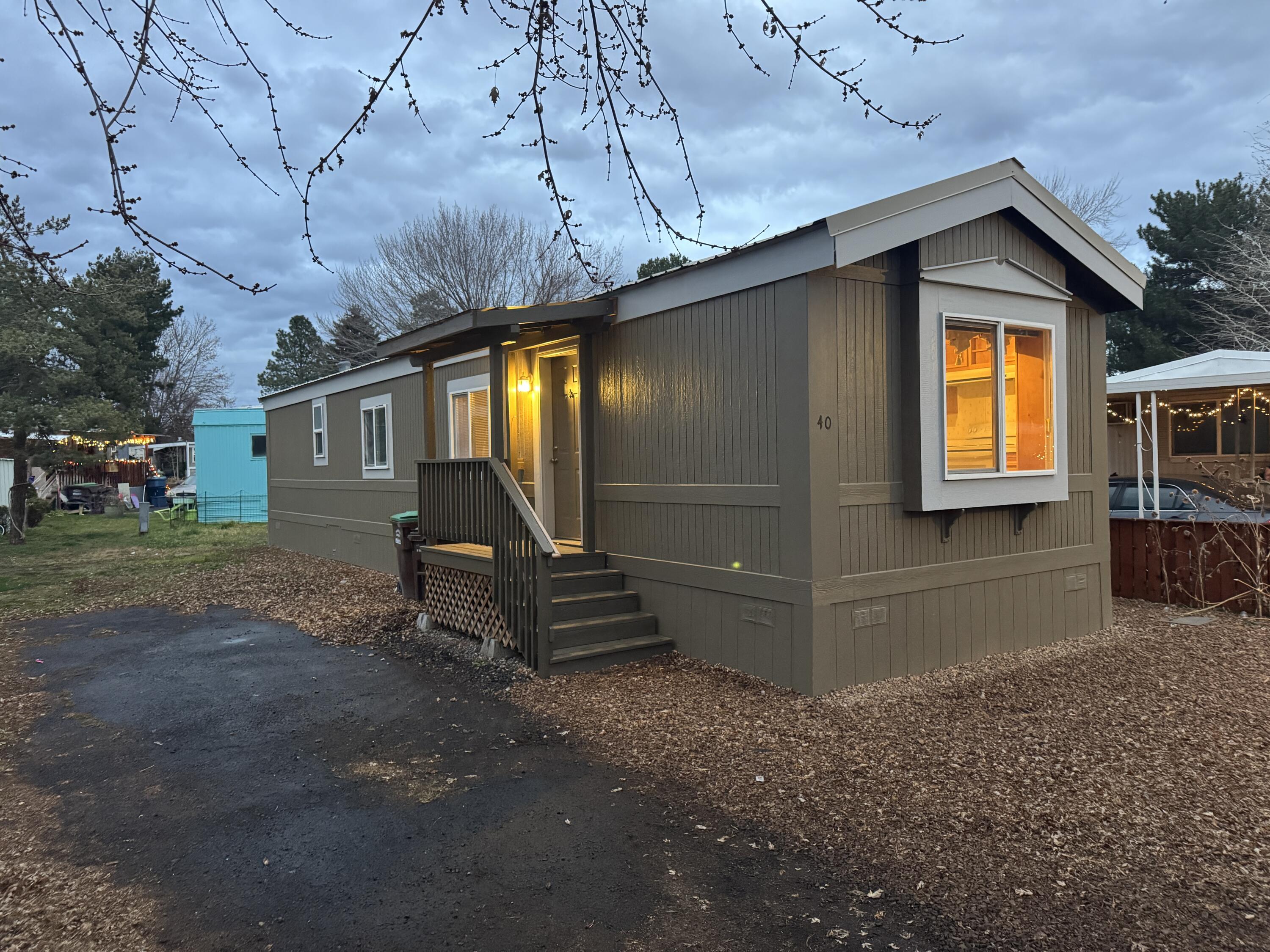 Beautifully remodeled home in an affordable park with new siding and metal roof! One block from Crook County High School & Crook County fairgrounds.  This move-in-ready property is in excellent condition and perfectly situated near shopping, dining, schools, and all local amenities. Enjoy an open floor plan with abundant natural light, and a well-designed layout ideal for comfortable living. All appliances are included, making this home truly turnkey. Don't miss this fantastic opportunity in a great location! One pet allowed. Water, sewer, garbage service, & snow removal included in space rent. Overflow & RV parking available for an additional fee.