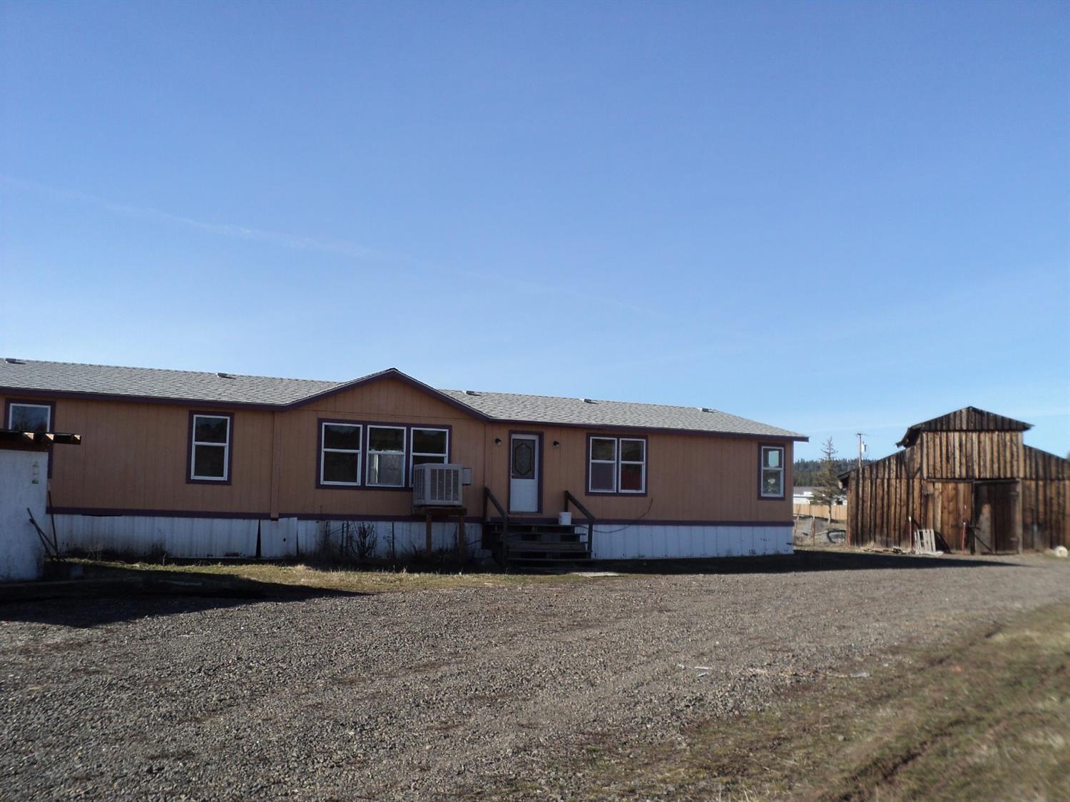 Great split level floor plan, in this updated 1998 manufactured home. 4 bedrooms, 2 baths, wonderful kitchen & mud room, Master suite with walk in closet and huge bathroom. Freshly painted inside & ready to movein! New roof and all but the kitchen and master bathroom windows are new. BIG BARN and 2 acres! Level, cross fenced. 30amp RV hook up and dump station. Property on two separate tax lots. Close in to Keno and school, yet just minutes to play in the woods, river and lakes! Good Buy. Conventional, cash or fha only.