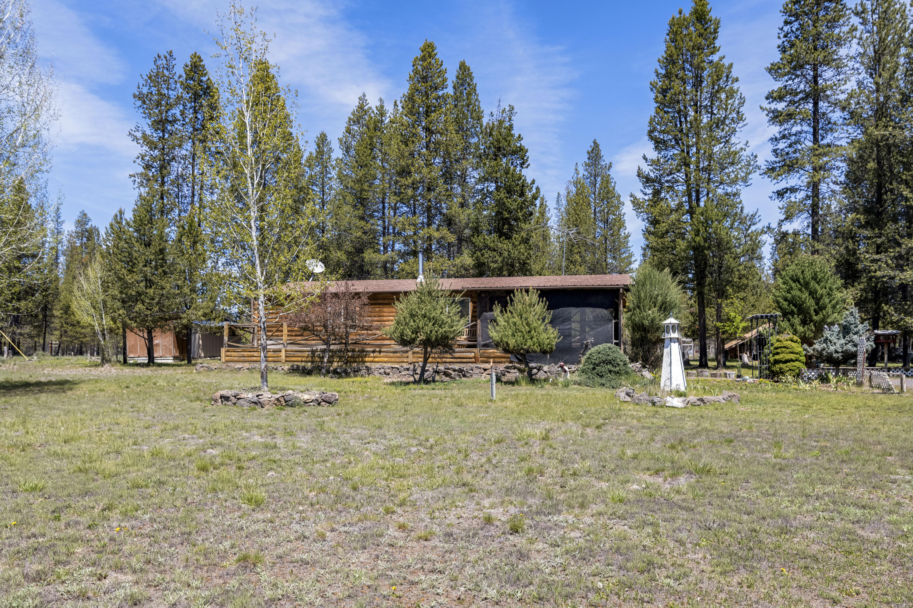 Seller Offering Painting Allowance with offer. Have your broker or agent contact listing agent with details. Sales Price Includes additional lot. This clean and cozy 2 bedroom, 2 bathroom, 1278 square foot manufactured home built in 1992 with log siding accents looks over a Sun Forest meadowed area. This home has multiple outbuildings and garden areas. Seller has an additional acre parcel included in this  sale. Located just miles from downtown La Pine, this would make the perfect home! Call your favorite Broker to come view this great home.