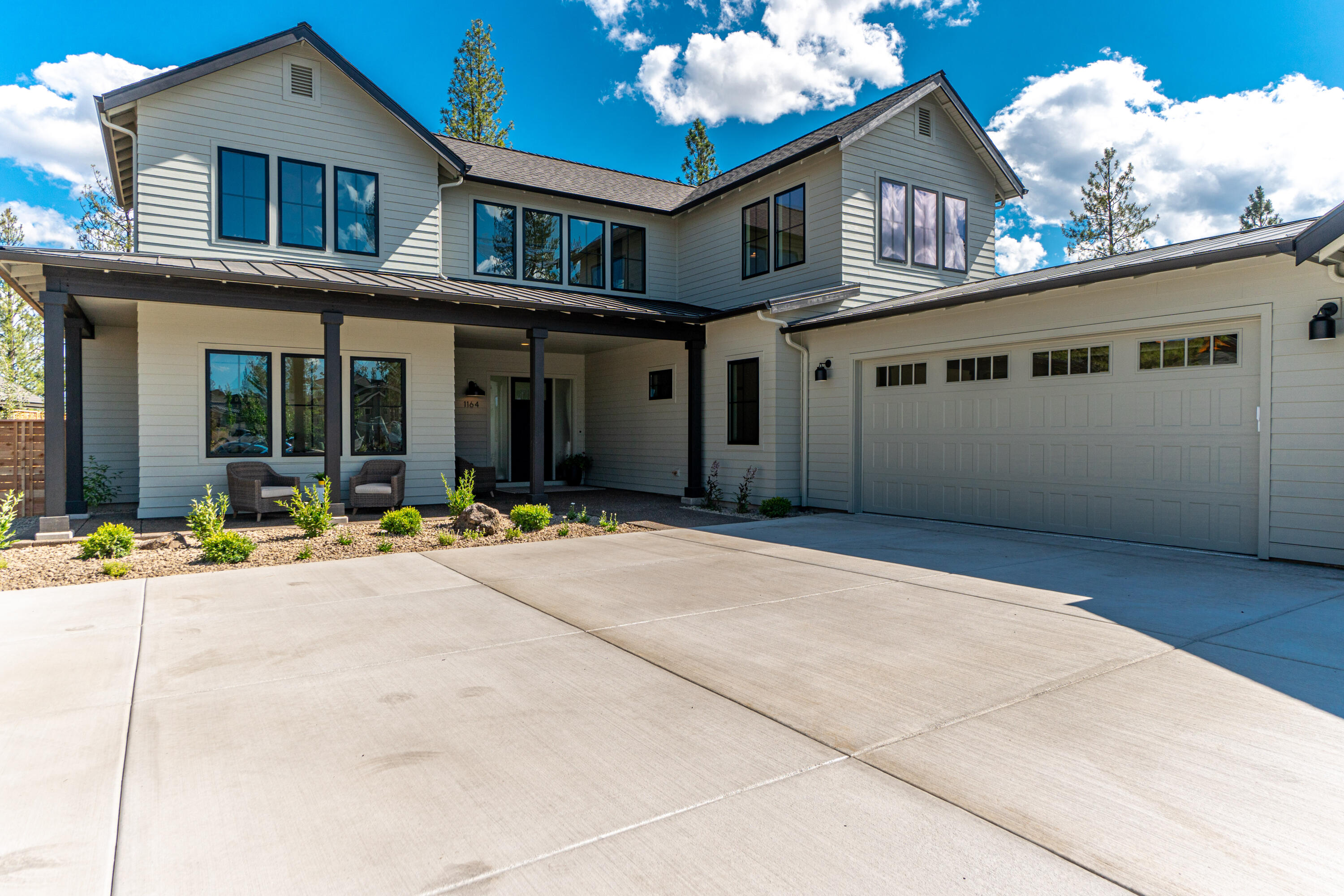 Luxury modern farmhouse home by award winning Greg Welch Construction in the highly sought after Discovery West neighborhood. Enjoy uncompromising craftsmanship & finishes throughout this stunning home, situated on a tree-dappled ridge overlooking Bend. Soak up sunshine in the open concept great room with abundant windows & oversized doors that seamlessly integrate the indoor & outdoor living areas. Entertain in the magnificent kitchen with an oversized island, butler's pantry & loads of storage. Primary suite is on the main level with spa-like bathroom. Office, gear room, mudroom & laundry are also on the main level. Bonus room, three bedrooms bedrooms & two full bathrooms on upper level. Situated on a large premier lot, this new construction home has a triple-car garage & is in the heart of the westside, close to schools, shopping & restaurants, along with the NW Crossing farmer's market on sunny summer days!