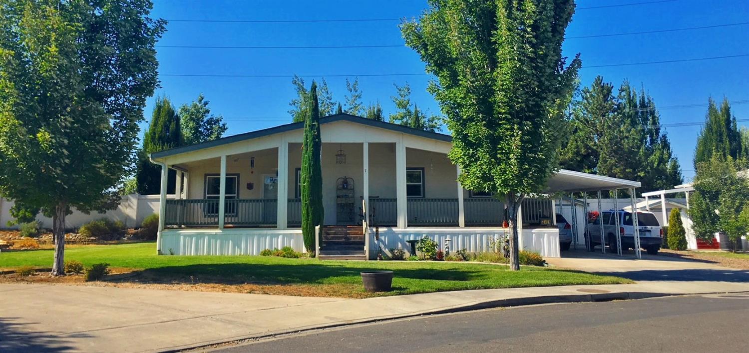 Fantastic home in a great location in San George Estates family-oriented community in Southern Oregon! This fabulous triple wide manufactured home offers 3 spacious bedrooms, 2 baths, 1920 sq ft of living space and nestled on a large corner lot. Super great open floor plan and vaulted ceilings throughout making it great for entertaining! The sizable master has huge walk in closet and large private bath with skylight drawing in lots of natural light. Enjoy your summer evenings from the expansive wraparound deck with built in wheelchair ramp. This home comes complete with 2 storage sheds, workbench, raised garden beds, carport, and access to the parks wonderful clubhouse, pool, exercise room, playground, library and RV storage! Don't miss this opportunity to be a part of a one of a kind neighborhood close to restaurants, shopping and more.