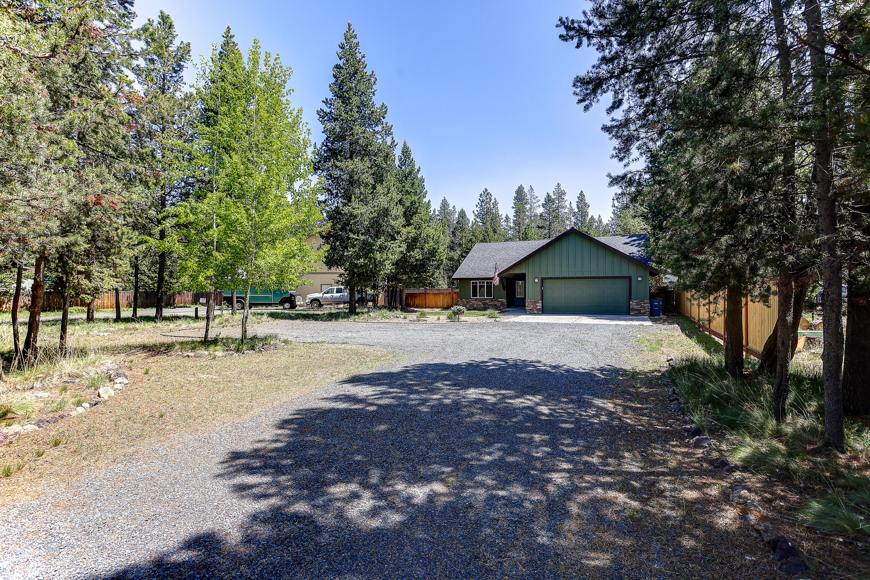 Nestled in a forest like sitting, this single-story craftsman-style home with 4 bedrooms & 2 bathrooms on .53 of an acre features an open concept floor plan, vaulted ceilings, a nice sized kitchen with stainless steel appliances, ample storage, under cabinet lighting, a breakfast bar & eating area that opens to the living room with a new wood stove. The spacious primary bedroom offers a large walk-in closet, tile shower & quartz countertop vanity. Enjoy the spacious private backyard with a great deck, and garden area & fully fenced. The HOA includes a community marina & dock on the Big Deschutes River, water, sewer, road maintenance, and snow removal.