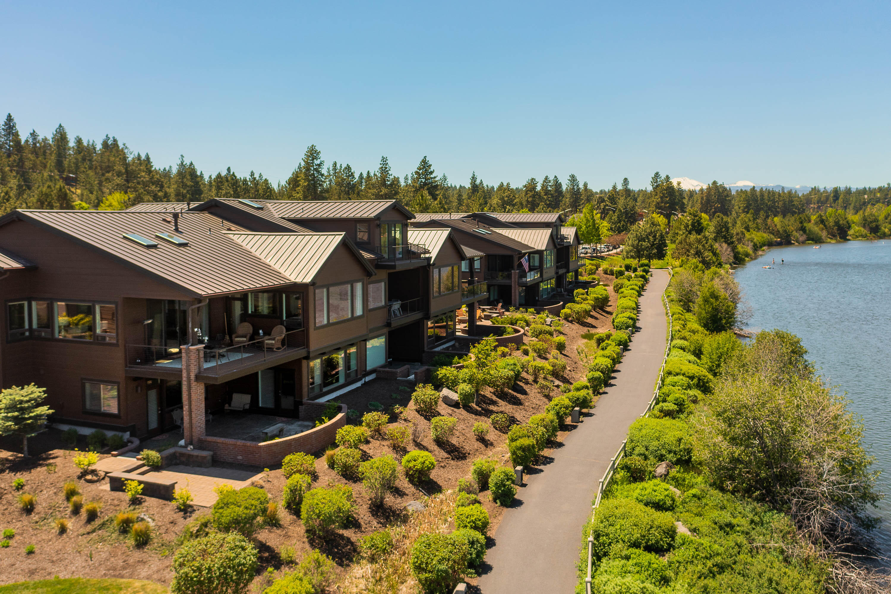 Opportunity knocks with this beautiful home on the Deschutes River in the iconic Old Mill District! Watch the summertime floaters from your upper or lower patio.  Enjoy beautiful river and mountain views & glorious sunsets! This lightly lived in upgraded home boasts newer granite counters, carpet, kitchen lighting & pot rack, Miele dishwasher, silhouette blinds & drapes. Whole house water filtration, workbench & cabinets in garage were also added.  All appliances including SS fridge, newer washer & dryer stay!  There's even a sauna for relaxation!  Since most of the furniture is also included & the HOA takes care of all the exterior tough stuff, you can start enjoying the Bend lifestyle immediately.  3156 sq ft of wonderful living awaits-generous bedrooms, great room up, family/entertaining room down and wonderful cook's kitchen.  Cozy gas fireplace, lots of storage for all your toys and just moments away from shops, restaurants, parks and concerts!