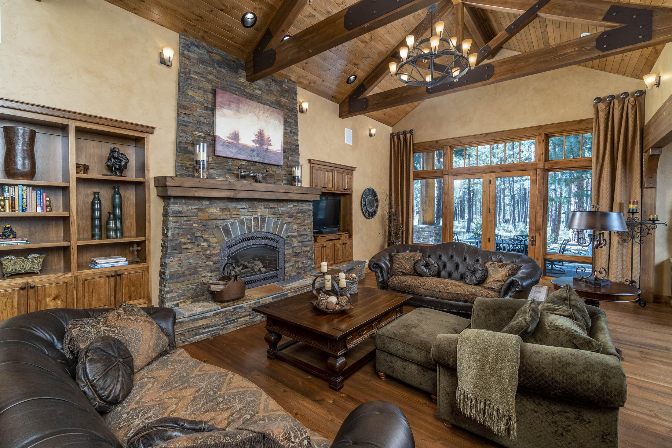 Dramatic Schumacher home has a warm, rustic elegance with all the luxurious touches you would expect in a custom home in Caldera Springs. 3 bedrooms (all bedrooms are suites w/ private baths) plus an office on the main level. Upstairs you will find a large bonus/game room w/ wet bar, corner fireplace & full bathroom.  Vaulted great room w/ exposed beams & stacked-stone fireplace; open kitchen w/curved granite sitting bar. Distressed hardwood flooring, extra wide hallways w/ arched custom woodwork, travertine stone, copper vessel sink, hot tub & much more. High end/quality finishes throughout. Sold furnished & ready for you to enjoy!
