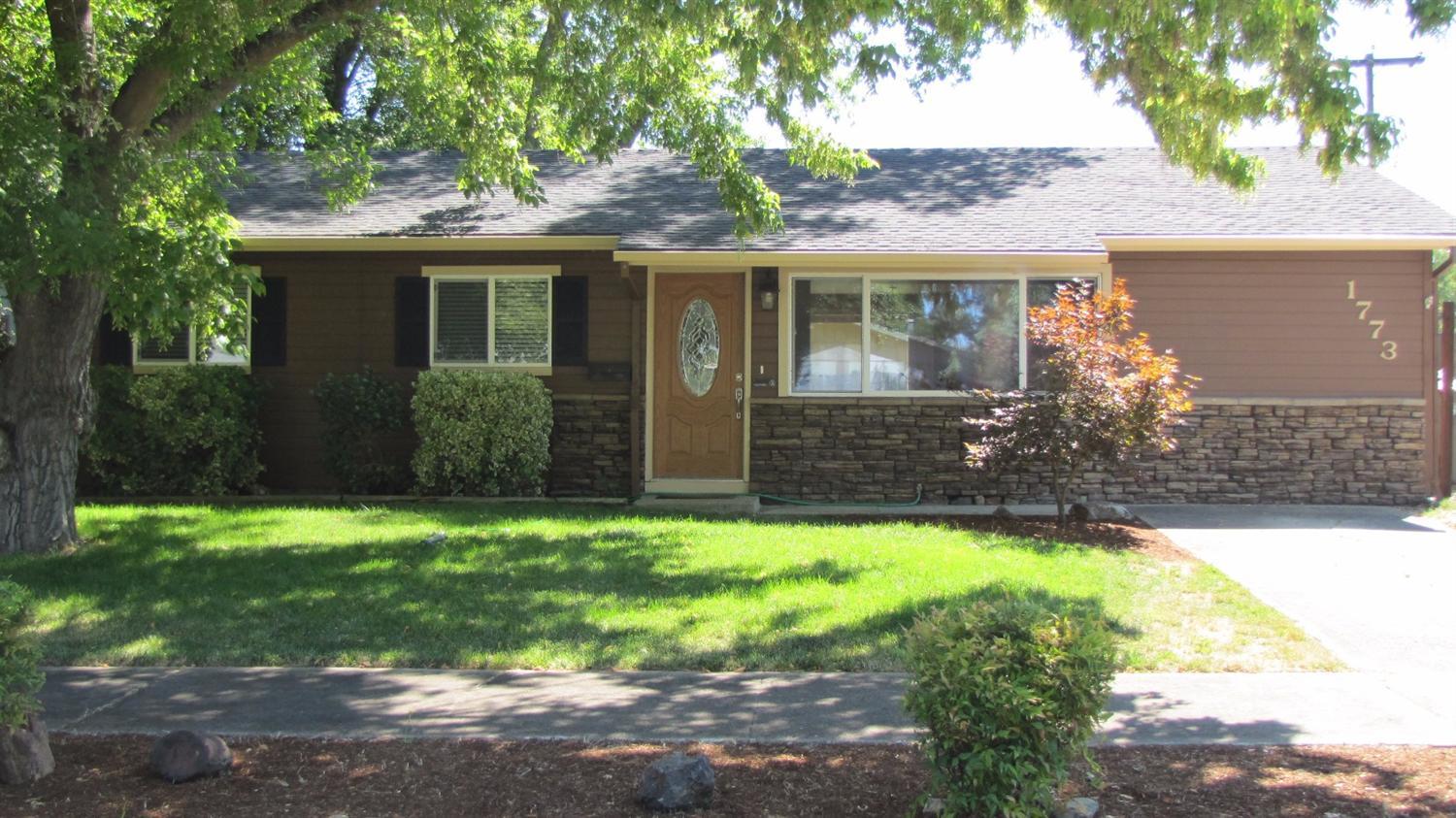 Extensively remodeled, spic & span move-in ready! Great location in Southwest Medford, close to South Medford High School. Nice neighborhood of well-kept homes. Recent updates include brand new bathroom from the studs up, new interior doors, fixtures, hardware, lighting, freshly painted interior & exterior. Newer roof, heating/air system, double pane vinyl windows. Laminate wood flooring in kitchen and hall, tile flooring in bathrooms. Large family room has built in shelving, gas rock fireplace with hearth and mantel. Kitchen has granite slab countertops gas range/oven, eating area with slider out to new cement slab patio! Large corner lot with ample room for RV parking and/or garage/carport addition. Refrigerator included. Seller will provide one year Fidelity Home Warranty for buyers!