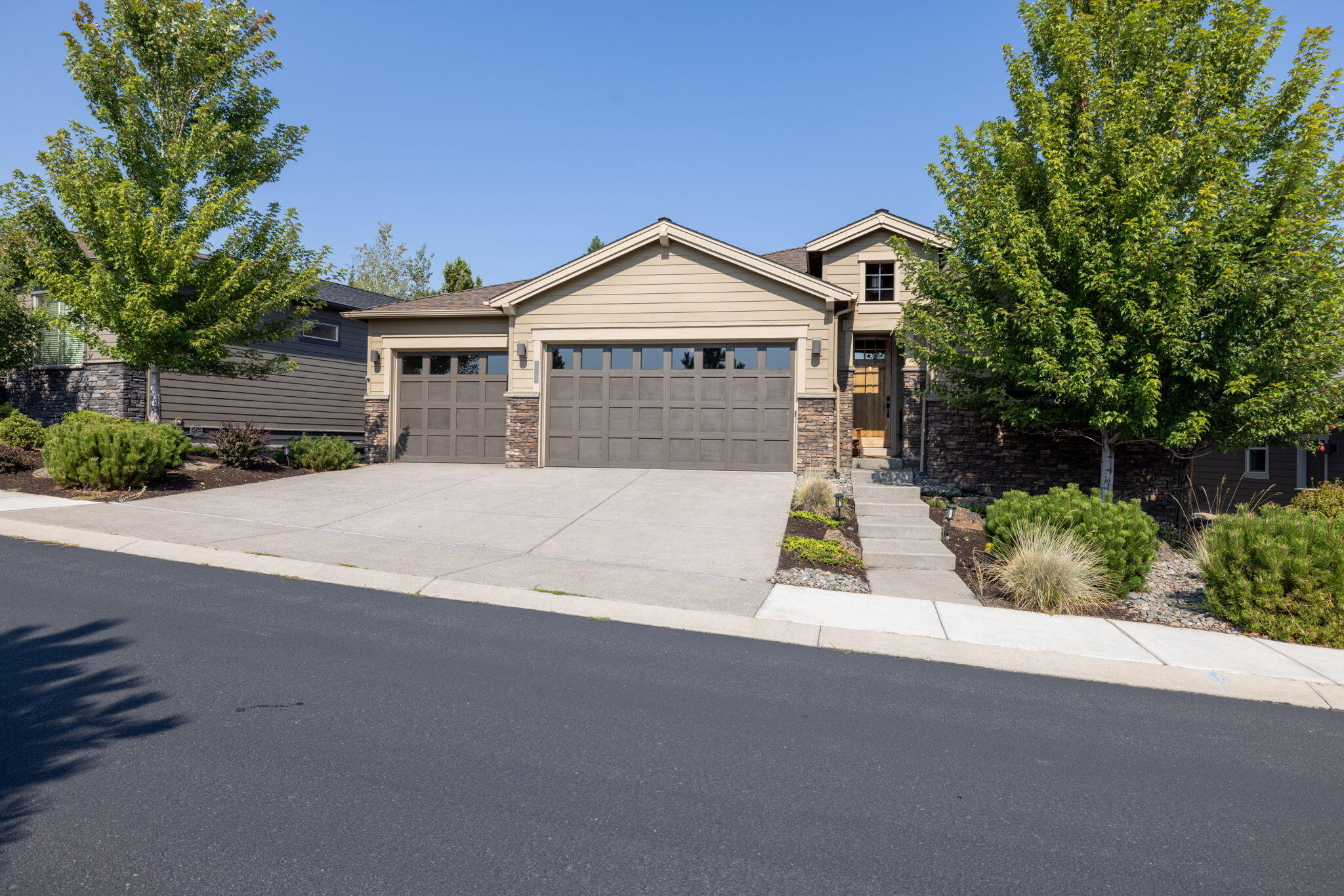 Wonderful Price Adjustment!  This immaculate, single-level Pahlisch home represents one of the best values in NW Bend. Vacant & move-in ready, this high-quality modern residence offers stunning territorial views, direct trail access, & proximity to the nearby golf course.  The inviting entry opens to a spacious great room featuring soaring ceilings, a stacked-stone fireplace, custom built-ins, and expansive windows that fill the home with natural light. The chef's kitchen is beautifully appointed with KitchenAid appliances, a 6-burner range, quartz countertops, walk-in pantry & alder cabinetry.  The primary suite includes a coffered ceiling, soaking tub, tiled walk-in shower, and a large walk-in closet. Additional highlights include engineered hardwood floors, 9-foot ceilings, 8-foot doors, and a spacious 3-car garage.  Outdoors, relax on the covered back patio, enjoy low-maintenance yard, or head straight out to nearby trails w/ quick access to the Deschutes River & Downtown Bend.