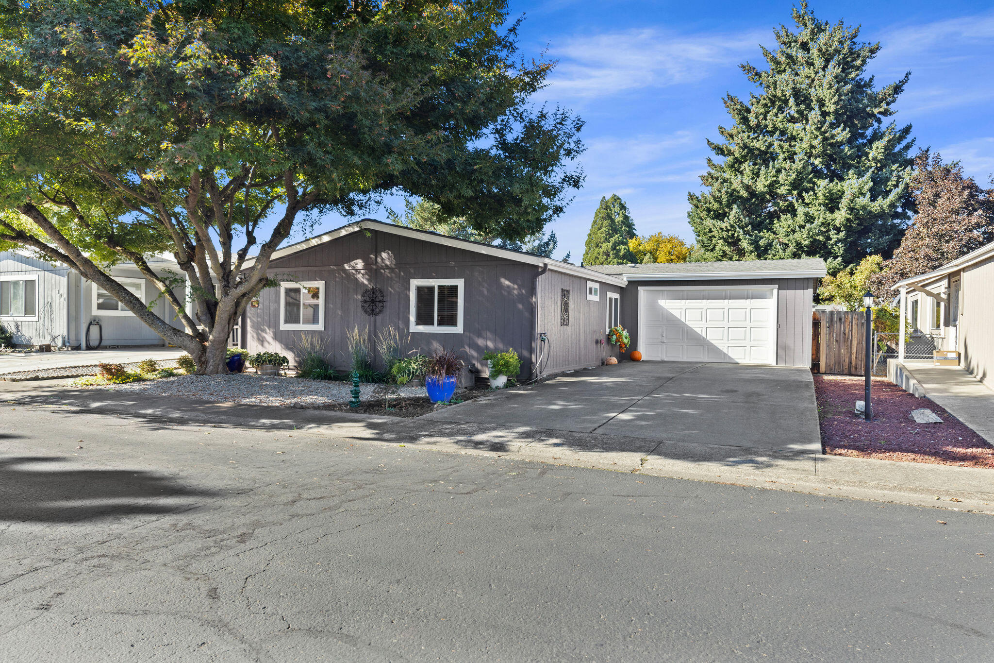 Adorable & Move-In Ready!  This home has been completely remodeled.  Including new windows, laminate flooring throughout.  New interior and exterior paint, appliances, cabinets/counter-tops, light fixtures, toilet.  Generous patio with a private and intimate backyard for outdoor entertaining needs with plenty of room for gardening, and a new 10X8 storage shed for your lawn/garden and holiday storage.  Located in ''The Meadows'' 55+ is close to shopping and easy access to I-5.  Full club house offers a gym, pool, community activities, full kitchen, pool tables, rental for private parties available.  RV storage on-site for a small fee.