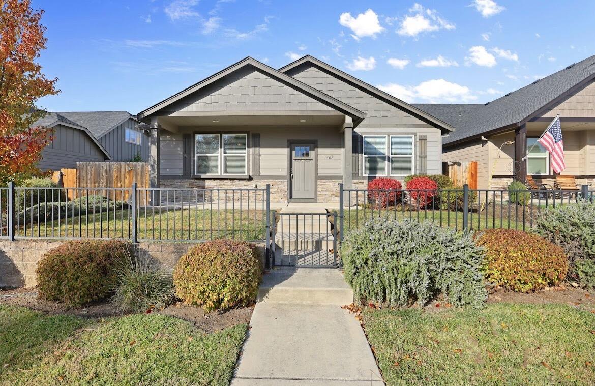 Welcome to this beautiful 3 bed, 2 bath East Medford home with a 3 car garage. Inside, you'll find a spacious living room with a cozy gas fireplace and an open floor plan that feels bright and inviting. The kitchen offers ample storage, granite countertops, a large island, and stainless steel appliances, making it great for hosting or everyday use. Off the dining area is a covered patio and a fully fenced yard with two gates for easy access. The generous primary suite includes a walk-in closet and an en suite with double sinks and a tile shower. You'll also appreciate the dedicated laundry room, low maintenance landscaping, and extra driveway parking. This immaculate single level home sits in a quiet, established neighborhood close to top rated schools, parks, medical facilities, restaurants, and shopping.