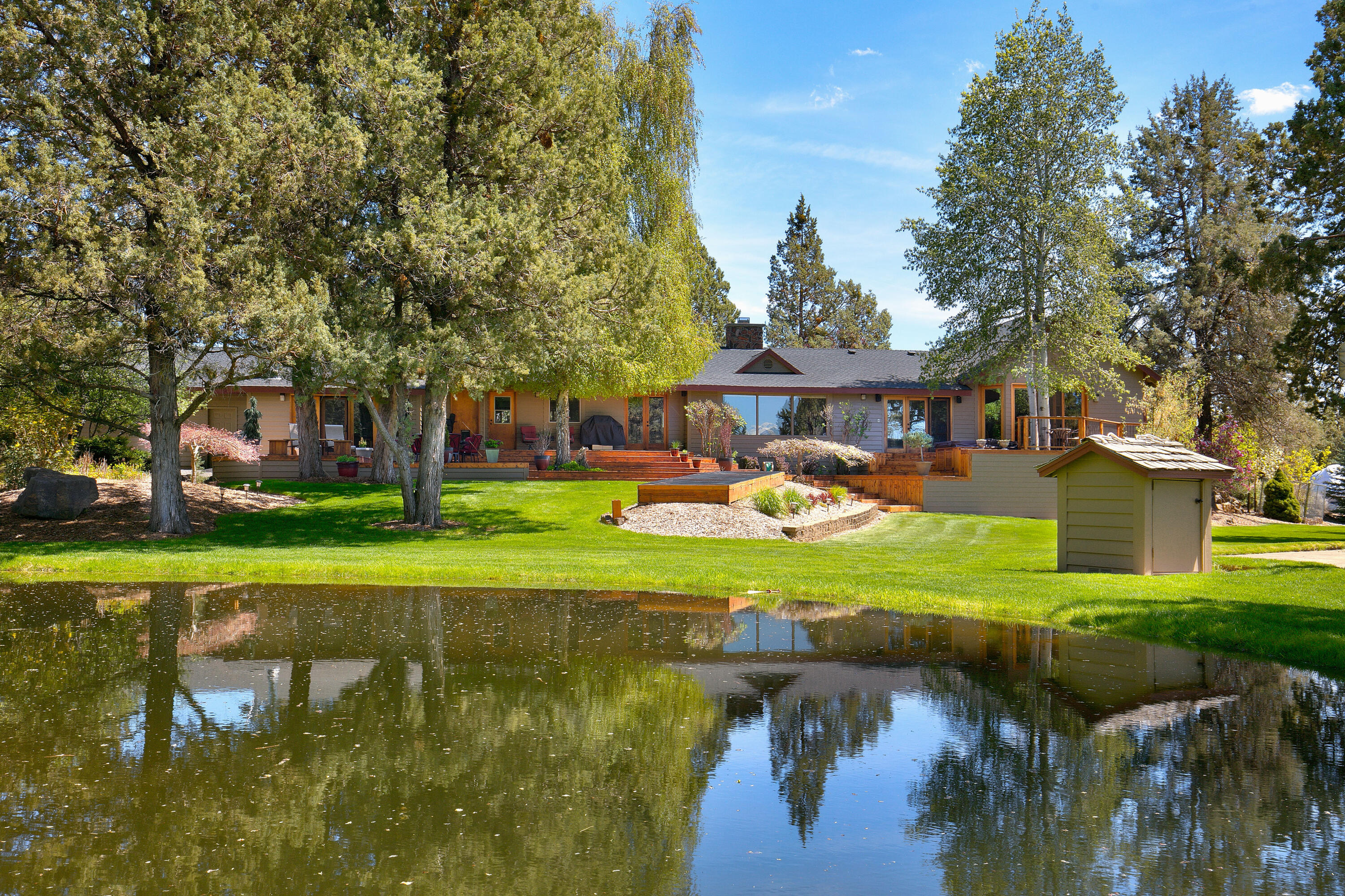 Country Home on 5 acres with 3.75 acres COID water rights minutes from NE Bend. Cascade Mountain Views from home deck in a park like setting. Updated and well maintained, single level ranch style home is 3320 sq ft, 4 bedrooms, 3 bathrooms, large master suite  with with spacious walking closet, master bath has tiled shower, a soaking tub with views and deck access to hot tub. Chef's kitchen with granite countertops, breakfast bar and SS appliances.  Living room has vaulted ceilings, views and wood burning fireplace. Dining Area, wine room, bonus room with wet bar, wet/dry sauna, attached 4 car garage with a shop area. Beautiful outdoor living with landscaped yard, large pond, mature trees, raised bed garden and green pastures. Barn with shelter for livestock, tack room and green pastures.  Storage building with carport and room to park the recreational toys/vehicles. Minutes from Pine Nursery Park. Wonderful opportunity for a private setting close to Bend!