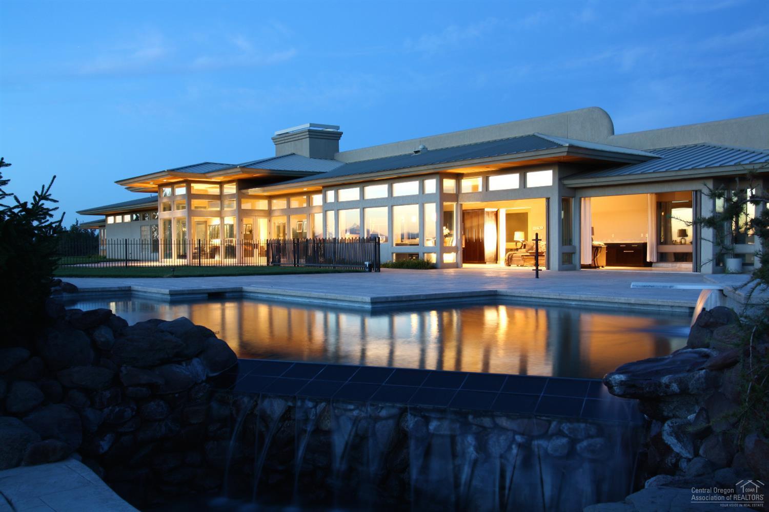 Exquisitely Remodeled Estate with all new, HVAC, Electrical, Pool Systems, & too much to list. 8 minutes from Bend on 25 acres w/long private driveway. One level home is 6804sf with soaring windows & breathtaking views of the Cascades. Formal living/dining room, extraordinary finishes throughout, 5 master suites, theater room, Sonoran Cactus ceiling, heated floors & triple car garage. Outside enjoy the Pebble Tieck pool, 7 water falls, hot tub, outdoor fire pit & a 3700sf+ 400amp fully insulated 6 Car Shop!