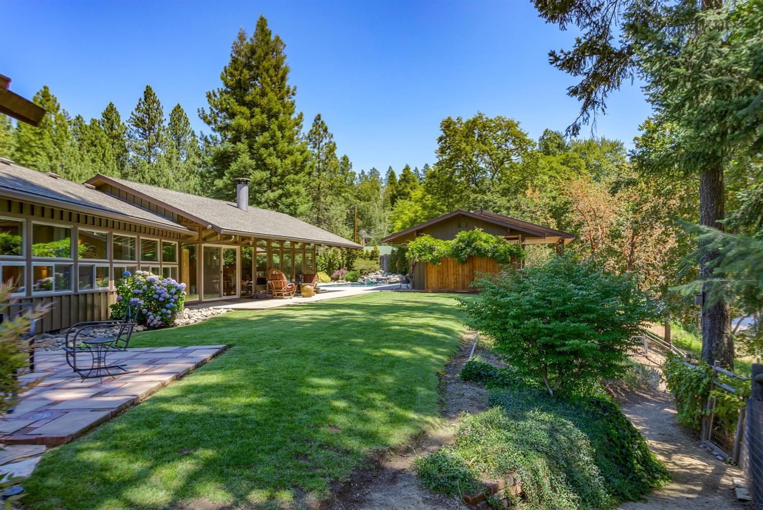 This special mid century modern river home was built along the banks of the Rogue River with 175' of River frontage, Once the jewel in the Spalding Mill complex, the home has been enhanced to compliment the original concept. The 2216 SF main home has travertine tile floors, luxury comml grade carpet in the 4 bdrms & hallway. Quartz countertops adorn solid wood kitchen cabinets, custom tile accents & eating bar. The laundry area adjoins the spacious hobby/office area with a full wall of cabinets - no shortage of storage space here! An add'l room/office is located just outside the master bedroom with tranquil River views & is not included in the SF. The 560 SF Pool house has a bedroom partition, living rm,kitchenette & bath with a large deck overlooking the Rogue River. An exterior water closet is included within the pool equipment room for easy access by pool users. Irrigation is provided via water rights. Gated entry and easy drive thru for RVs. Welcome Home!