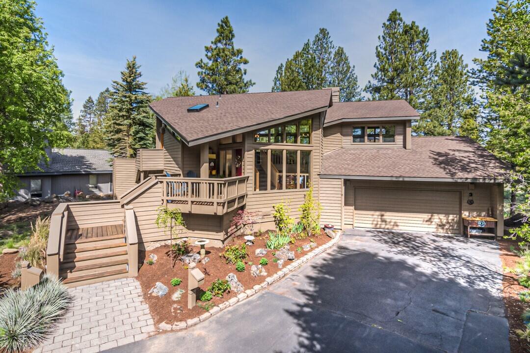 Searching for a Sunriver home filled with natural light and views of pine trees? This beautifully updated home has everything you need and more. The primary bathroom has been redone, featuring a new tile shower that will make you feel like you're at a spa. You'll also love the fresh paint, new carpets, updated appliances, new light fixtures, window coverings, and new luxury vinyl plank flooring. This home is ready for its next adventure! The open floor plan features vaulted cedar ceilings, a custom mantle and a wrap-around gas fireplace that connects the living and dining areas. You'll appreciate the granite countertops in the kitchen and quartz in the bathrooms. Multiple decks offer plenty of outdoor entertaining options, plus the oversized 2-car garage provides plenty of room for all your needs. Located on a cul-de-sac in the north end of Sunriver, this home is coming partly furnished and is ready for you to move in and start enjoying.