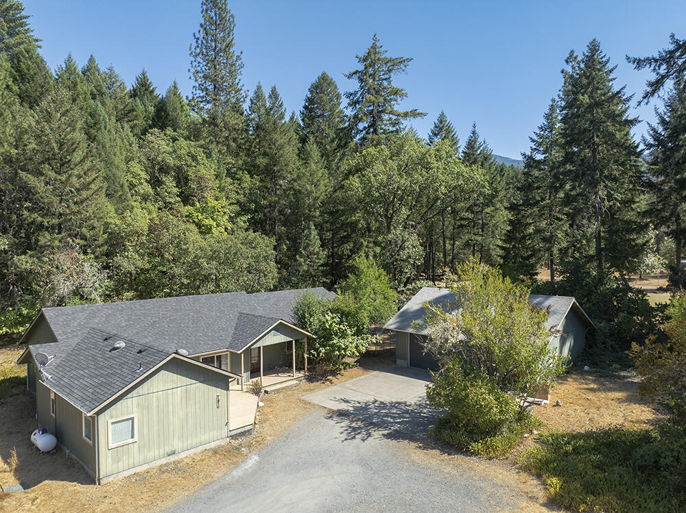 The Perfect Rural Home & Property! Located on a Quiet Country Road, you will find this 4 Bed, 3 Bath 2,202 SqFt Single-Level Home on a Beautiful Level & Useable 1.81 Acre Parcel. You will enjoy Privacy from Neighbors, a Pretty Setting with Mountain Views, & access to Public Lands just up the Road! Home Features a Comfortable & Functional Floor Plan, with a Huge Living Space, Attractive Country Kitchen, & a Fantastic Master Bedroom. The Master Bedroom features Laminate & Tile Floors, a Custom Tile Shower, Jetted Tub, Dual Vanities, & Walk-in Closet. Three Additional Bedrooms & Two More Full Baths make this Home ideally set-up for your Living Needs! The Retro-Style Utility Room will bring back fond memories. Awesome Three-Car Garage/Shop covers your Parking & Workspace Needs. Established Mature Fruit Trees & some Nice Landscaping. The Level Useable Land is the real star here, with TONS of Room for Gardens, Animals, & Kiddos! Home is set well back from the Road. You will LOVE this place!