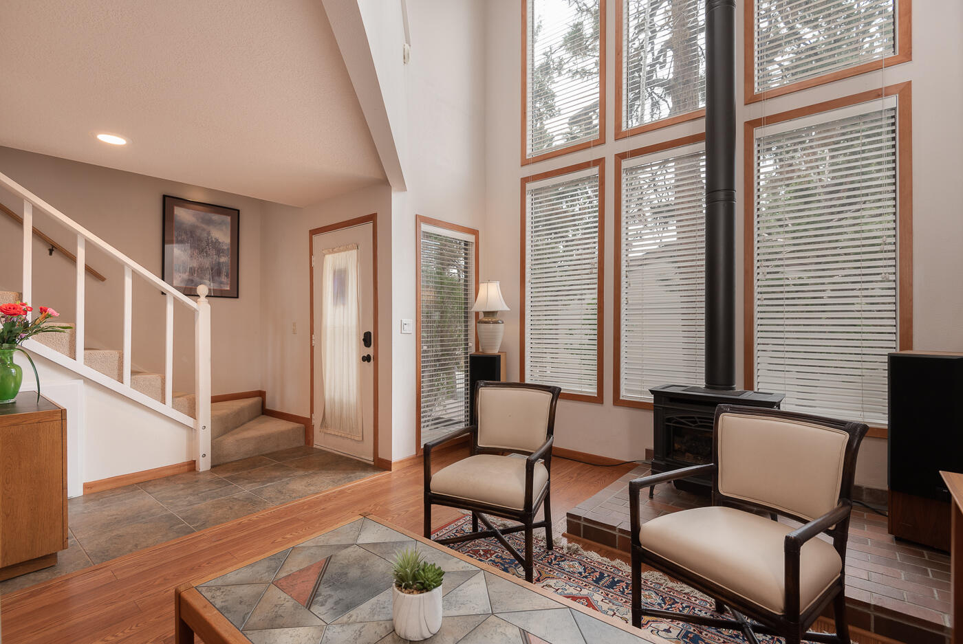 Perfectly placed and affordable condo.  Only a few blocks to river trails and downtown Bend.  Natural light from the floor to ceiling windows streams in and illuminates the heart of this home. Inviting and private back deck and upper front balcony both boast views of mature trees and landscaping.  The well thought out floor plan allows for separate living spaces to meet the needs of the purchaser.  The owner has invested in many upgrades to increase energy efficiency including a new heat pump (with central AIR CONDITIONING) and air sealing.  Please see attached docs for a list of owner additions  New high-end washer and dryer, refrigerator, and stove are included in the sale!