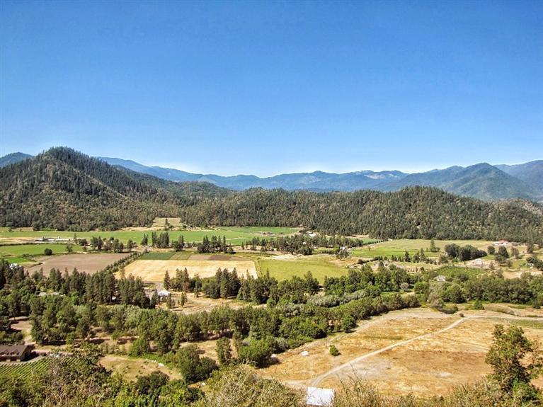 Gorgeous Applegate Valley Ranch! The legenday Krouse Ranch is the very essence of the Applegate Valley. This 275+ acre Vineyard property lies in the middle of the exploding Applegate Wine Country! With over 1/2 mile of Applegate River frontage, 2 large ponds, and over 40 acres of Pinot Noir/Cabernet, this property is ready for the next level. The 165 acres of primary and secondary irrigation rights, dating back to the 1800's, allows for expansion of the vineyard and Measure 49 allows for additional homesites with expansive views of the valley below. Beauty surrounds every inch of this property and there are several locations for a high end tasting room or wine cave. This will be a must stop on the Applegate Wine Tour! Don't miss the chance for a must see property in a must have location ~